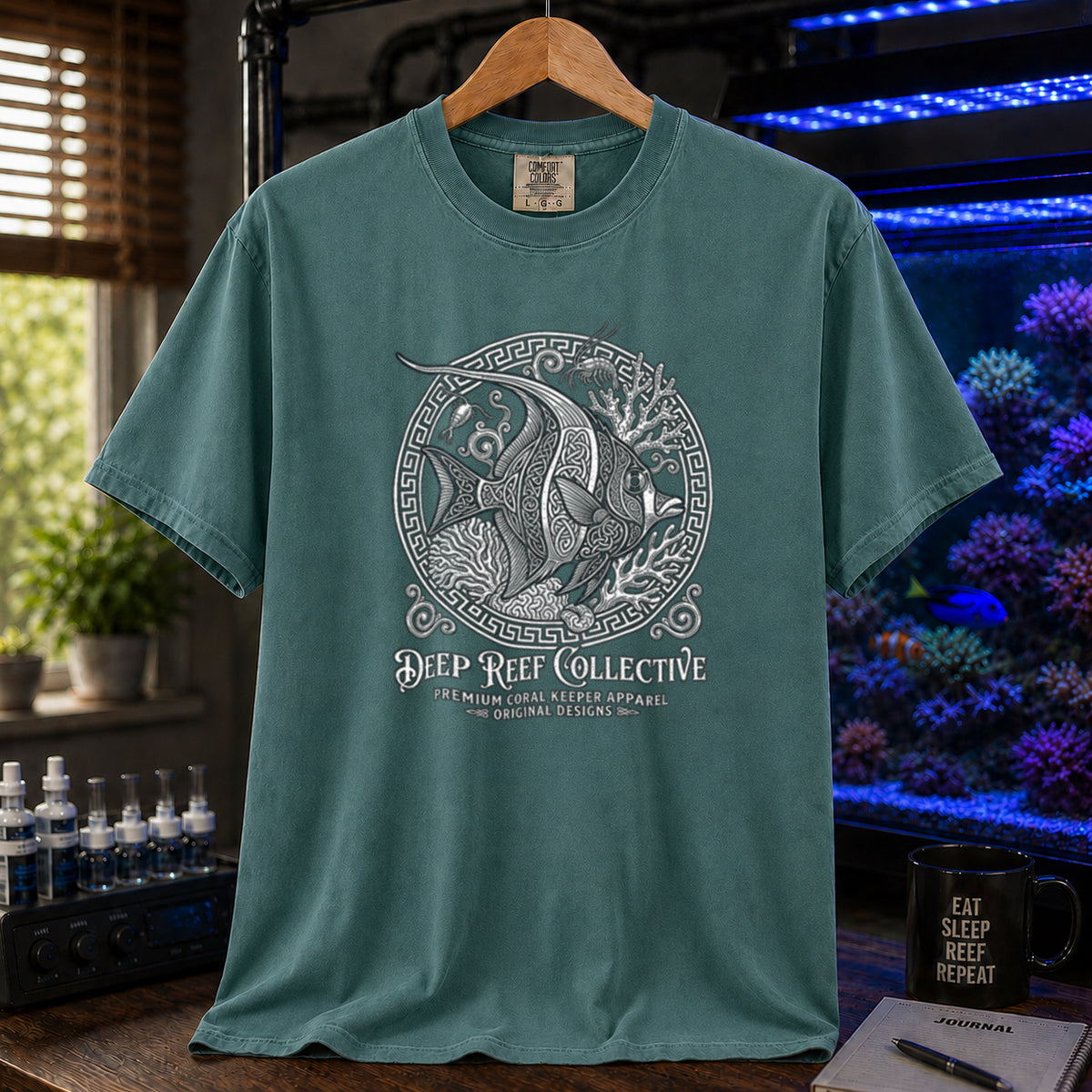 Deep Reef Collective saltwater aquarium graphic t-shirt featuring an ornate circular medallion illustration of a marine fish with the text: DEEP REEF COLLECTIVE, PREMIUM CORAL KEEPER APPAREL, ORIGINAL DESIGNS, green crew neck tee