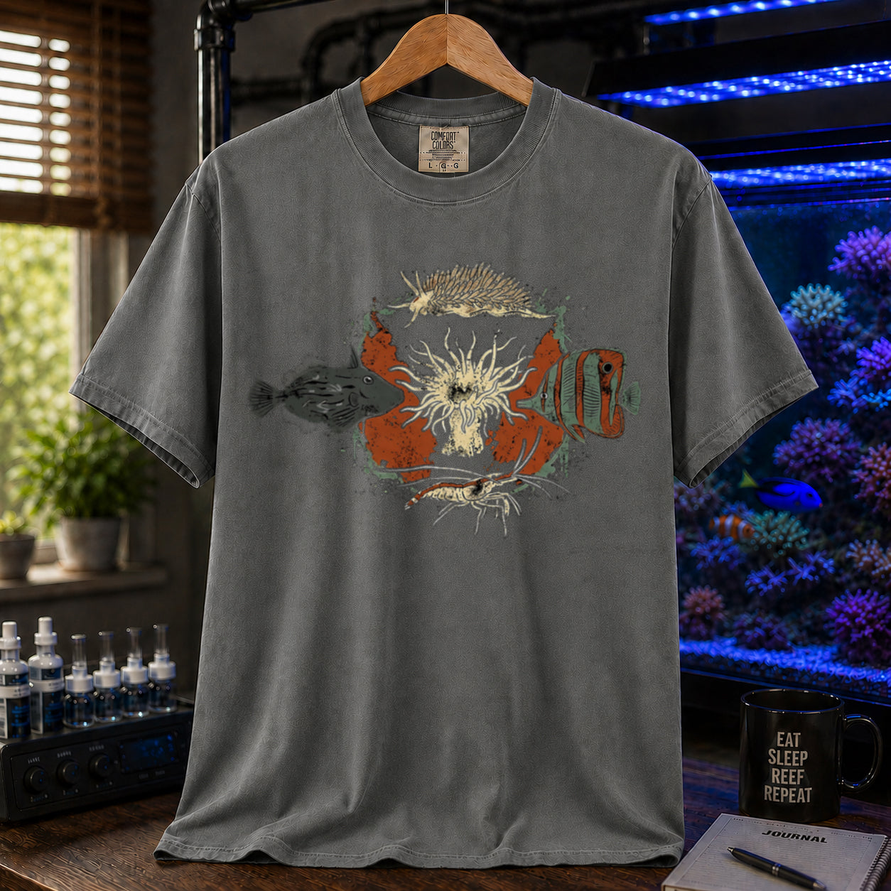 Saltwater aquarium graphic t-shirt featuring an illustration of biological Aiptasia predators surrounding an anemone and text: AIPTASIA CONTROL, khaki crew neck tee