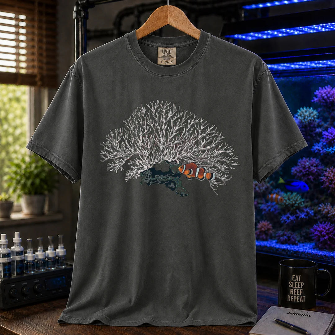 Saltwater aquarium graphic t-shirt featuring a detailed white branching coral illustration with a clownfish nestled underneath, khaki crew neck tee