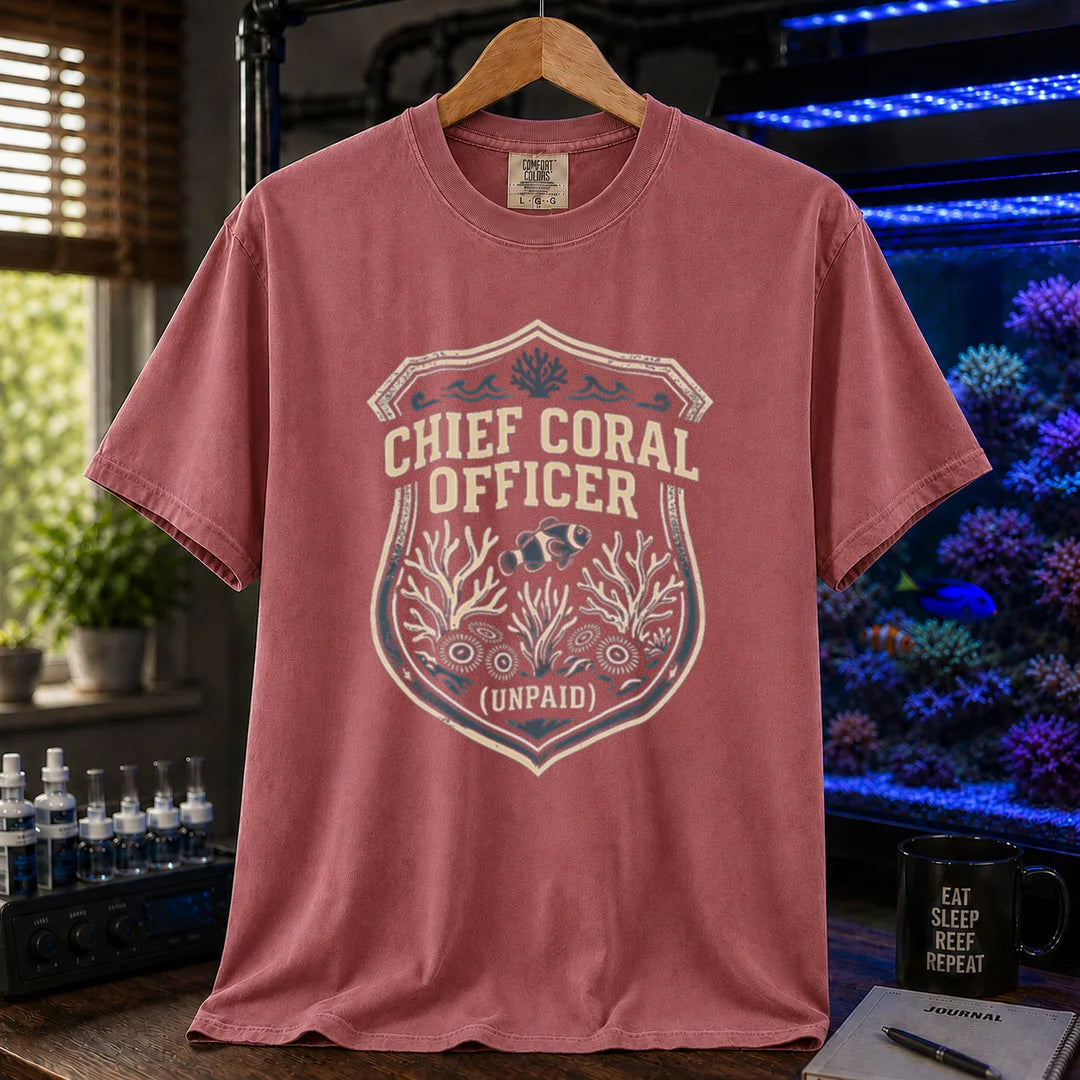 Saltwater aquarium graphic t-shirt featuring a badge illustration with text: CHIEF CORAL OFFICER (UNPAID), light red crew neck tee