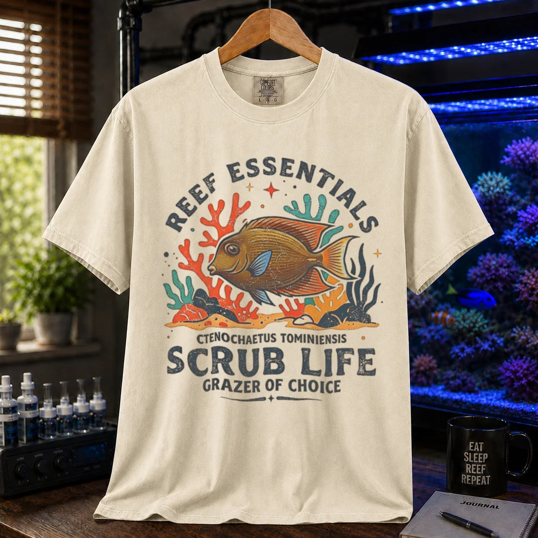 Saltwater aquarium graphic t-shirt featuring a Tomini Tang illustration and text: REEF ESSENTIALS SCRUB LIFE GRAZER OF CHOICE, cream, beige, ivory crew neck tee
