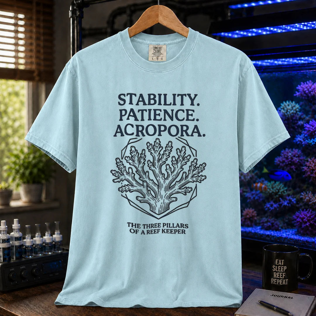 Saltwater aquarium graphic t-shirt featuring an Acropora coral illustration and text: STABILITY. PATIENCE. ACROPORA. THE THREE PILLARS OF A REEF KEEPER, light blue crew neck tee