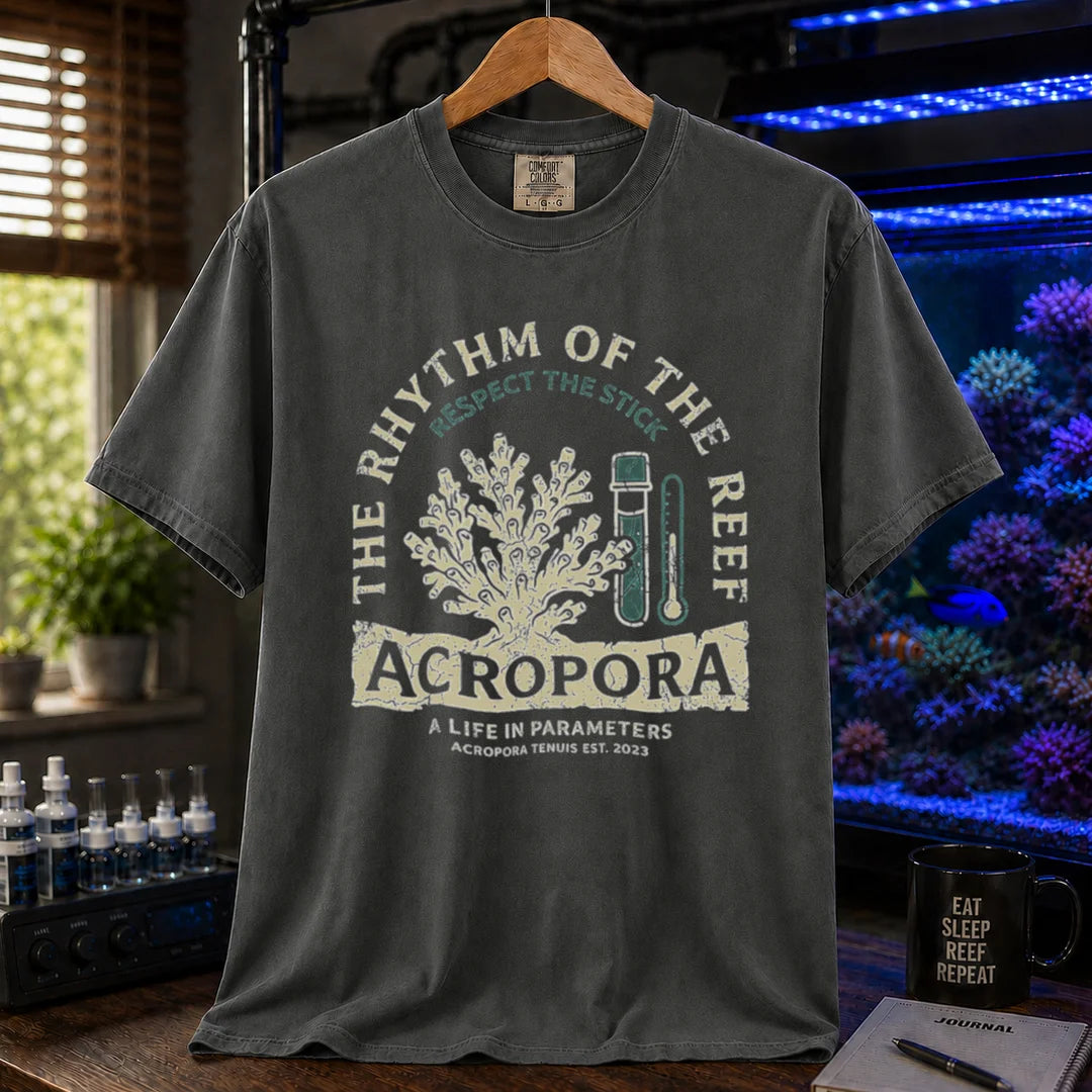 Saltwater aquarium graphic t-shirt featuring an Acropora coral and test kit illustration with text: THE RHYTHM OF THE REEF ACROPORA A LIFE IN PARAMETERS, dark grey crew neck tee