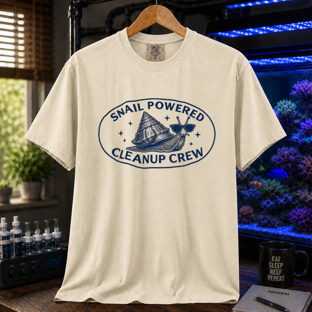 Saltwater aquarium graphic t-shirt featuring an oval emblem of a snail in sunglasses and text: SNAIL POWERED CLEANUP CREW, cream, beige, ivory crew neck tee