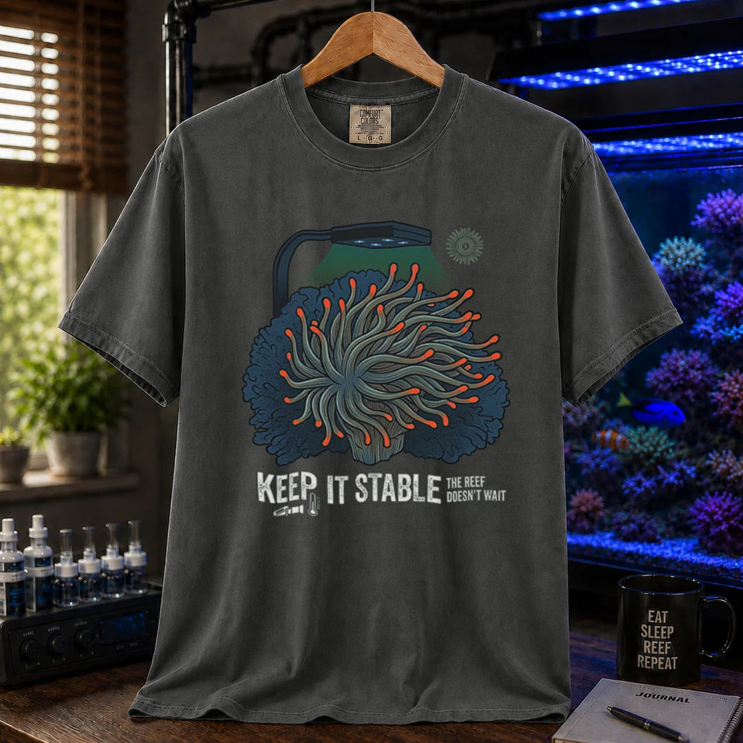 Saltwater aquarium graphic t-shirt featuring an anemone illustration under a reef light and text: KEEP IT STABLE THE REEF DOESN'T WAIT, dark grey crew neck tee