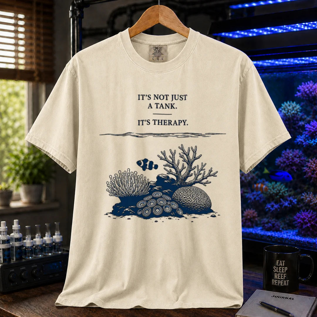 Saltwater aquarium graphic t-shirt featuring an underwater reef scene with a clownfish and text: IT'S NOT JUST A TANK. IT'S THERAPY., cream, beige, ivory crew neck tee