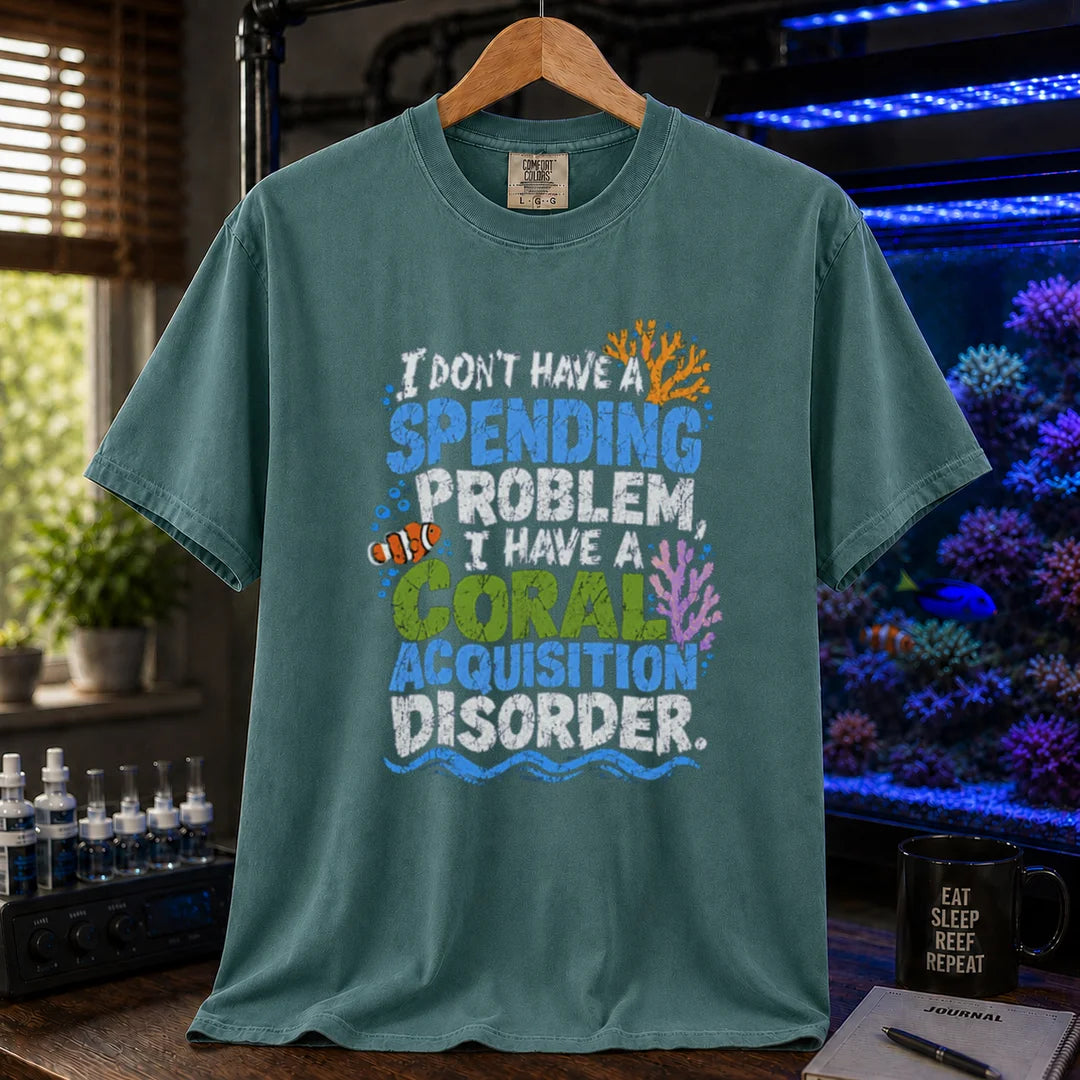 Saltwater aquarium graphic t-shirt featuring colorful distressed text reading I Don't Have A Spending Problem, I Have A Coral Acquisition Disorder with a clownfish and coral accents, green crew neck tee