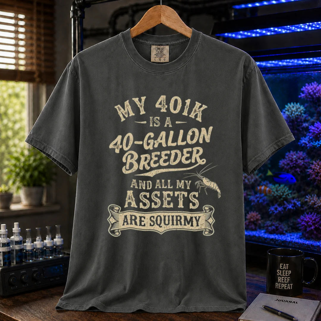 Saltwater aquarium graphic t-shirt featuring cream distressed typography reading My 401k Is A 40-Gallon Breeder And All My Assets Are Squirmy with a shrimp illustration, dark grey crew neck tee