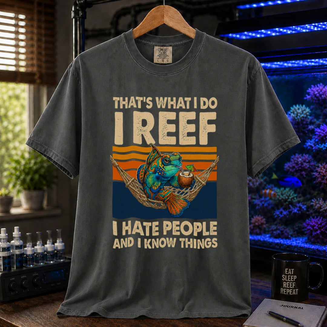 Saltwater aquarium graphic t-shirt featuring a mandarin goby in a hammock with a drink against a retro sunset and text reading That's What I Do I Reef I Hate People And I Know Things, dark grey crew neck tee