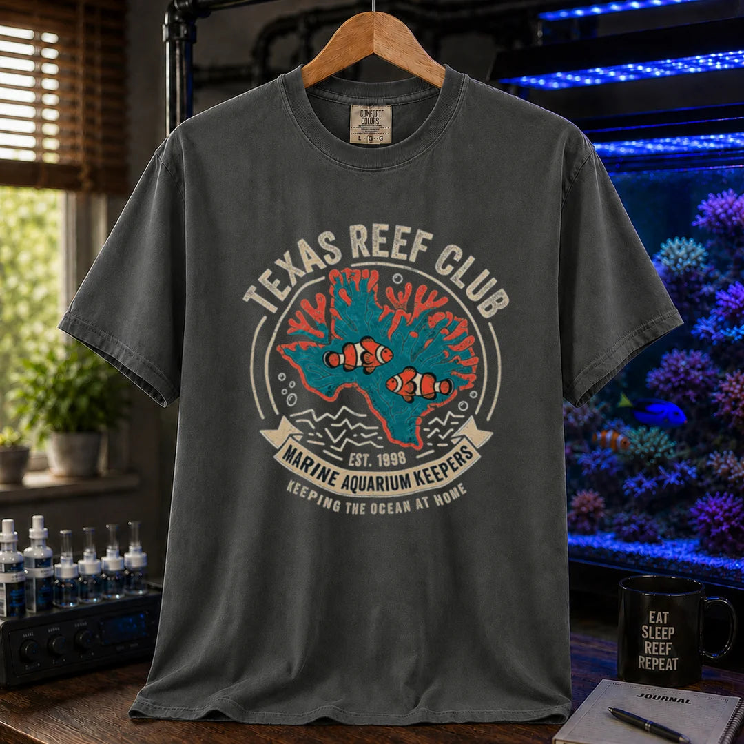 Saltwater aquarium graphic t-shirt featuring a vintage emblem with coral shaped like Texas, clownfish, and text reading Texas Reef Club Marine Aquarium Keepers Est. 1998, dark grey crew neck tee