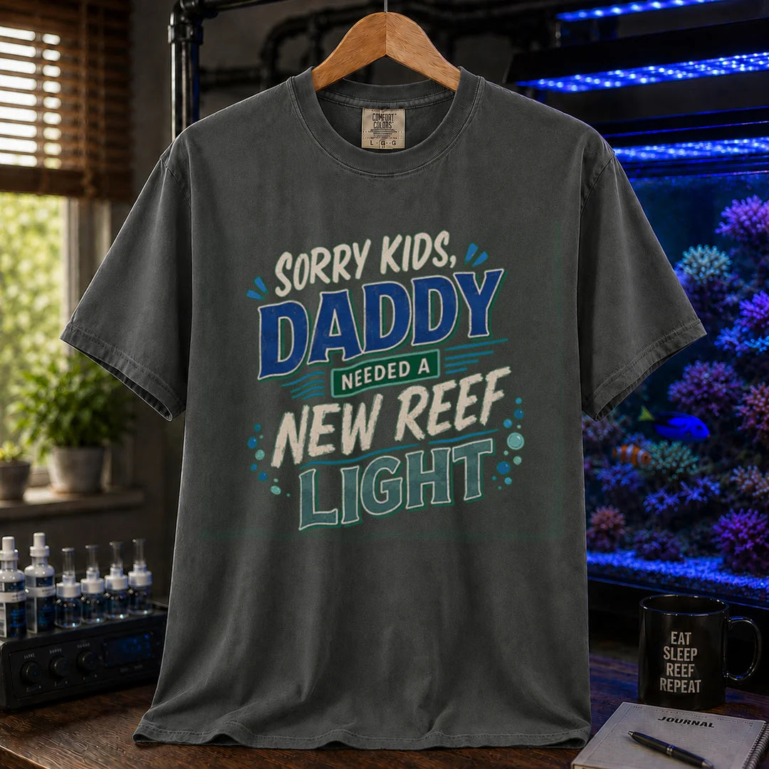 Saltwater aquarium graphic t-shirt featuring multi-color distressed typography reading Sorry Kids, Daddy Needed A New Reef Light with bubble accents, dark grey crew neck tee