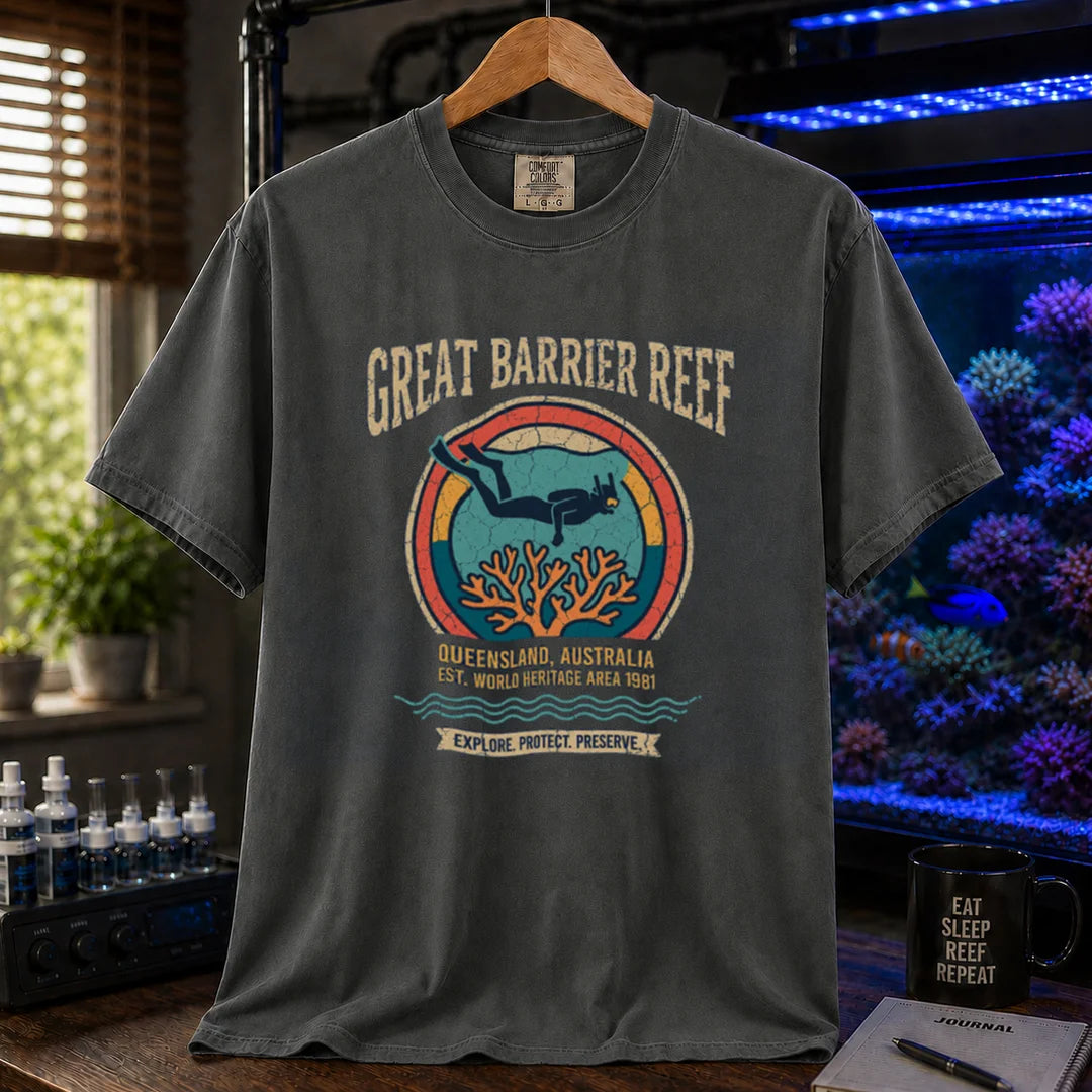 Saltwater aquarium graphic t-shirt featuring a retro circular emblem with a scuba diver and coral, arched text reading Great Barrier Reef Queensland Australia Est World Heritage Area 1981, dark grey crew neck tee