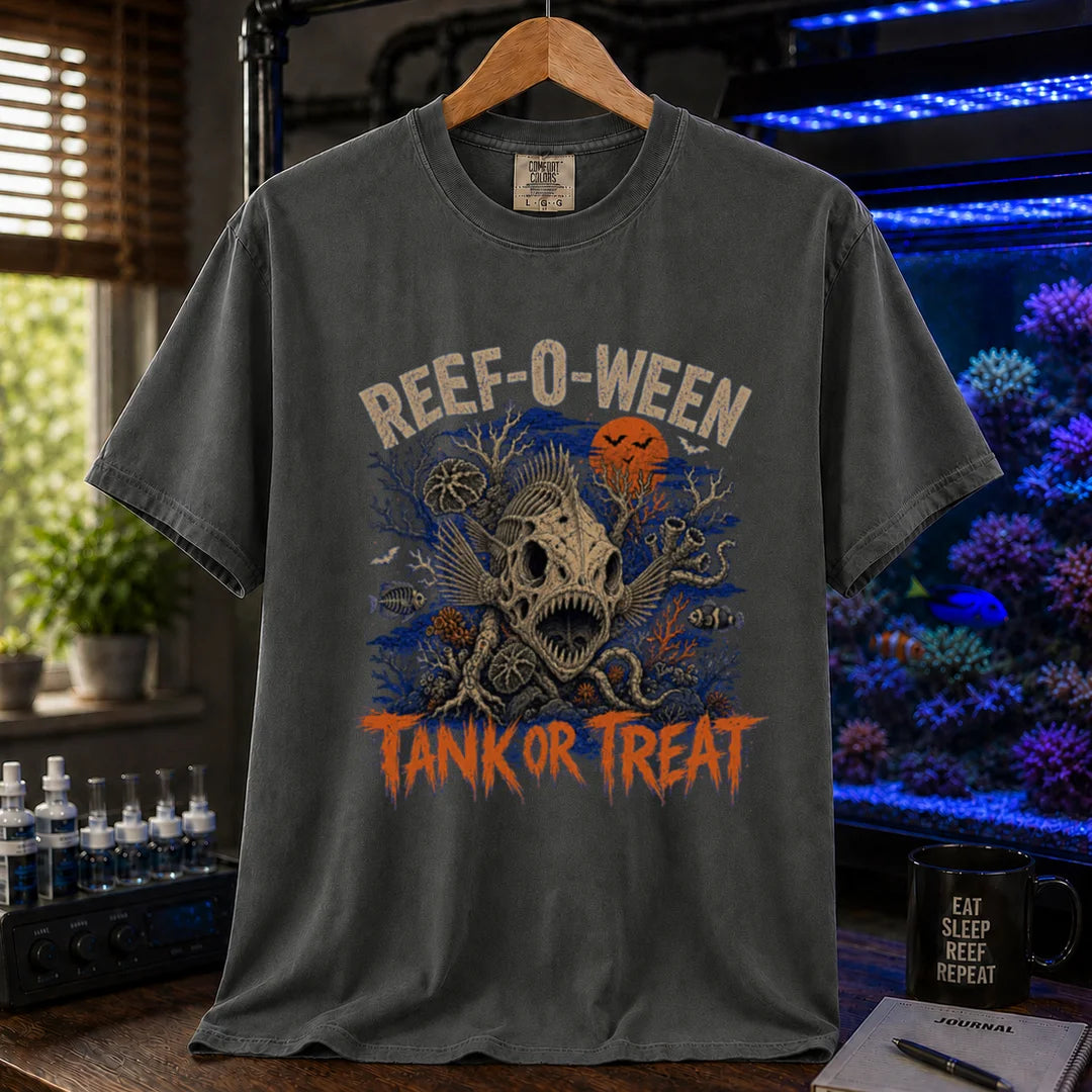 Saltwater aquarium graphic t-shirt design featuring cream arched typography reading Reef-O-Ween and dripping orange text reading Tank Or Treat with a large fish skull skeleton, full moon, bats, and spooky reef corals, dark grey crew neck tee