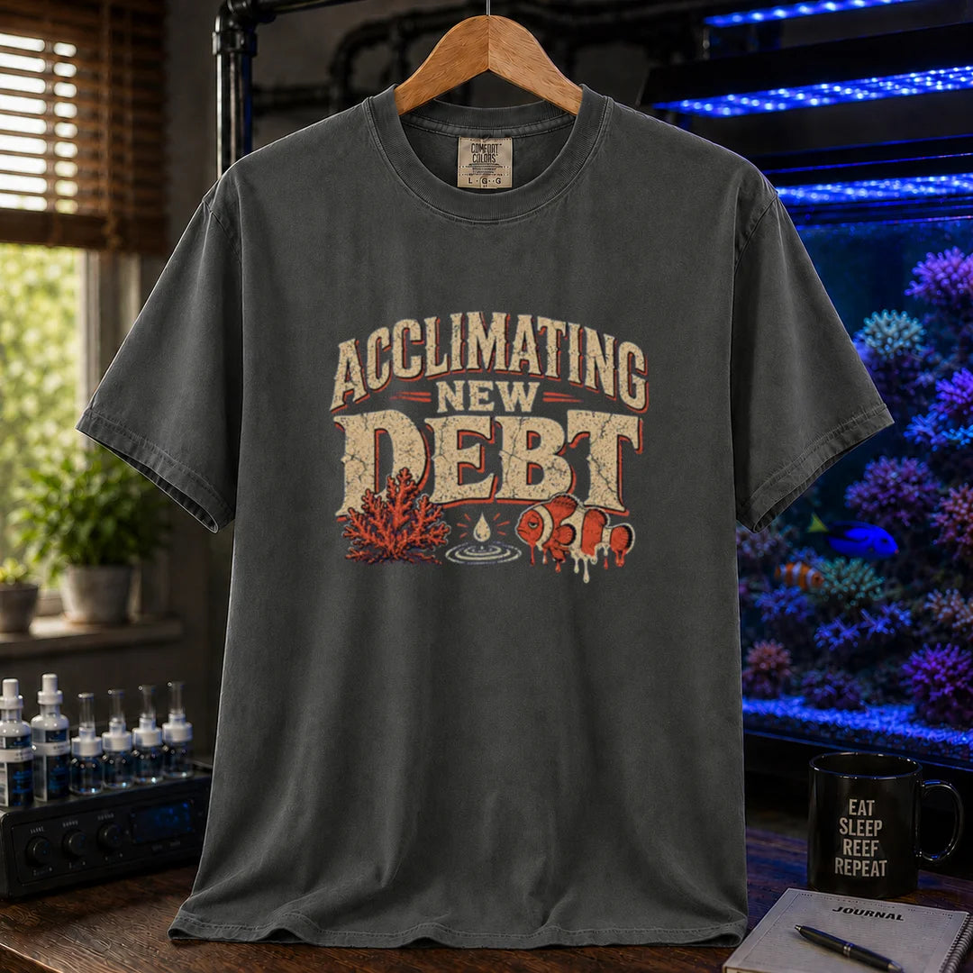 Saltwater aquarium graphic t-shirt design featuring distressed typography reading Acclimating New Debt with coral, water droplet, and clownfish illustrations on a dark grey tee