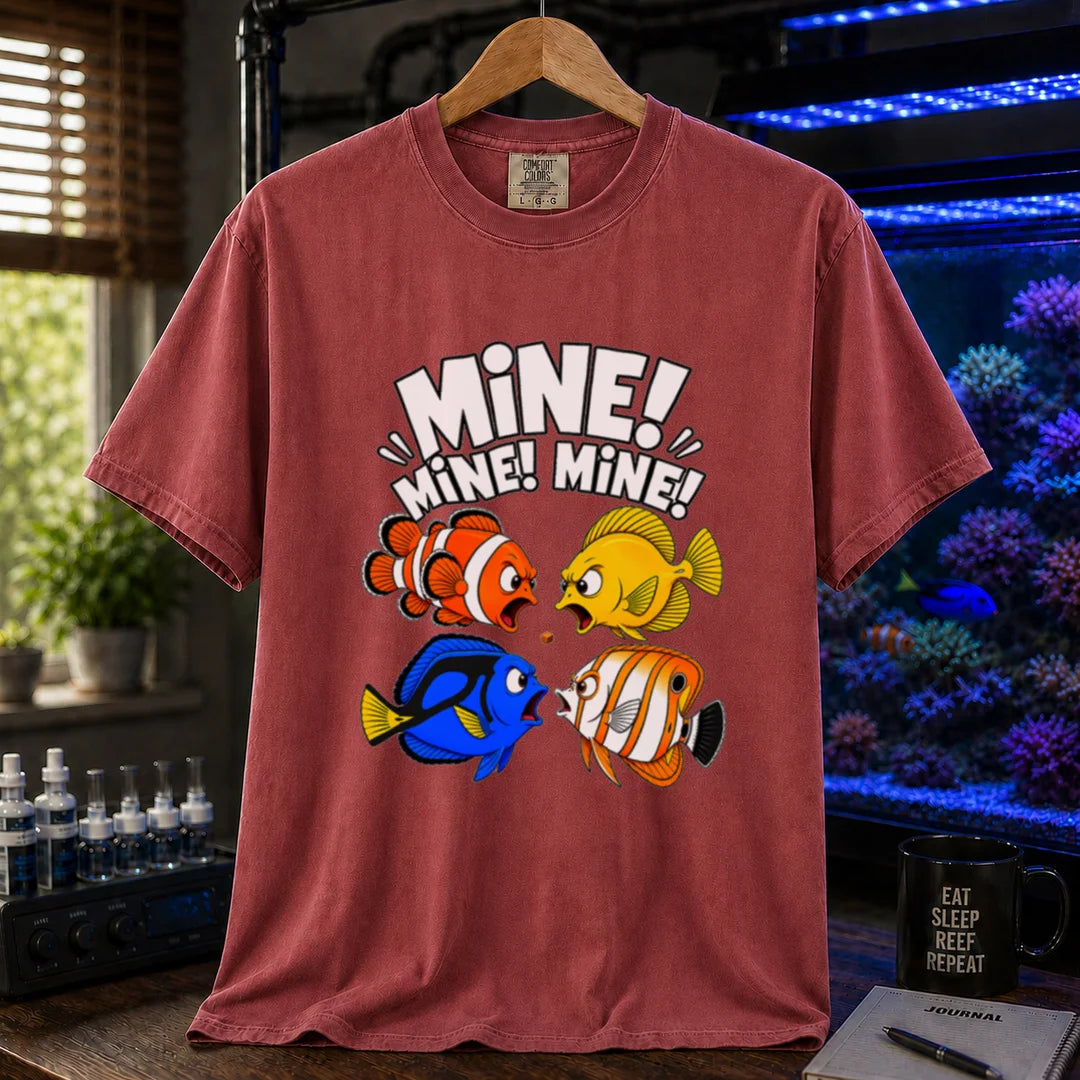 Saltwater aquarium graphic t-shirt featuring text reading Mine Mine Mine above four colorful reef fish fighting over a single piece of food on a maroon, red shirt