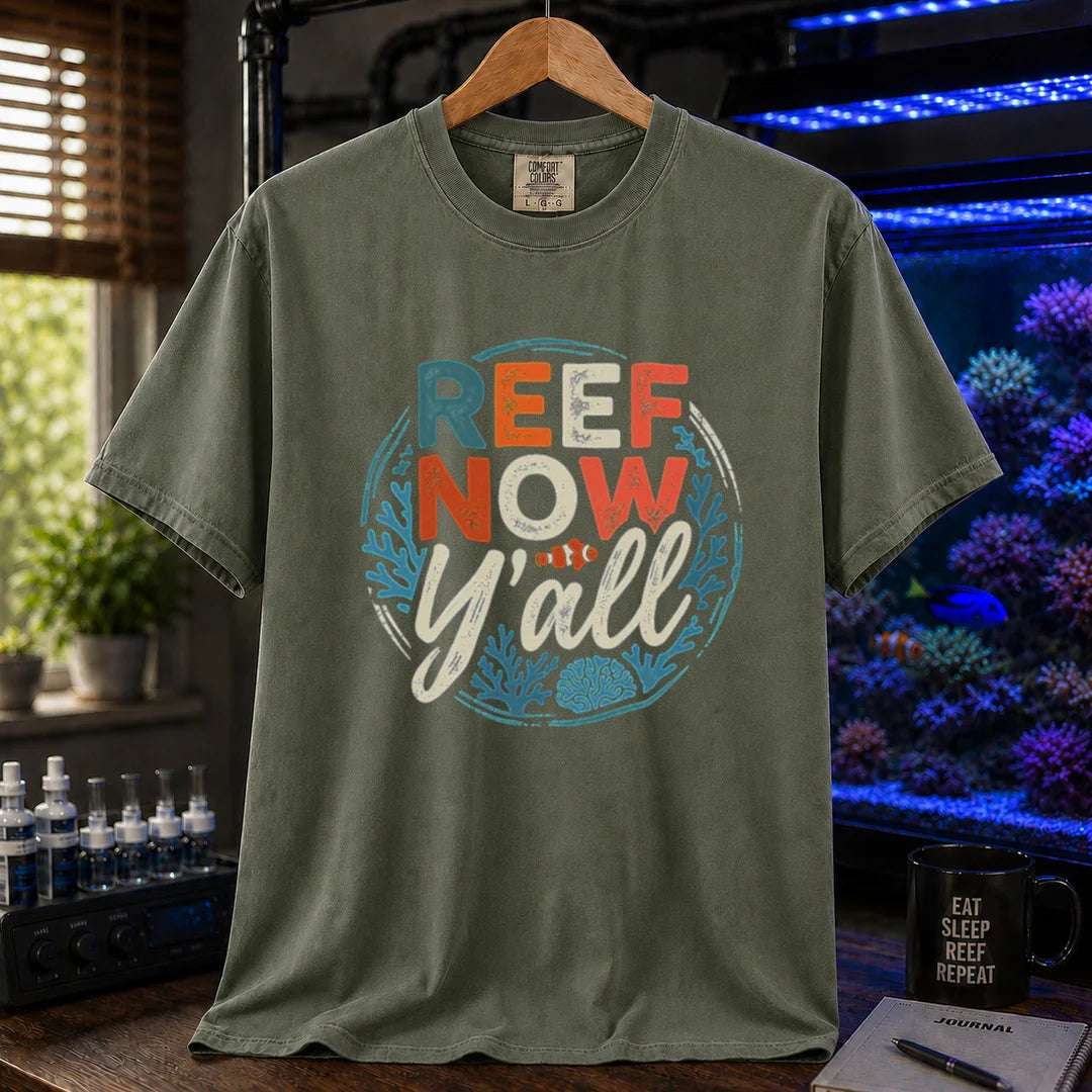 Saltwater aquarium graphic t-shirt featuring a circular distressed emblem with typography reading Reef Now Y'all and a clownfish illustration on a military green shirt