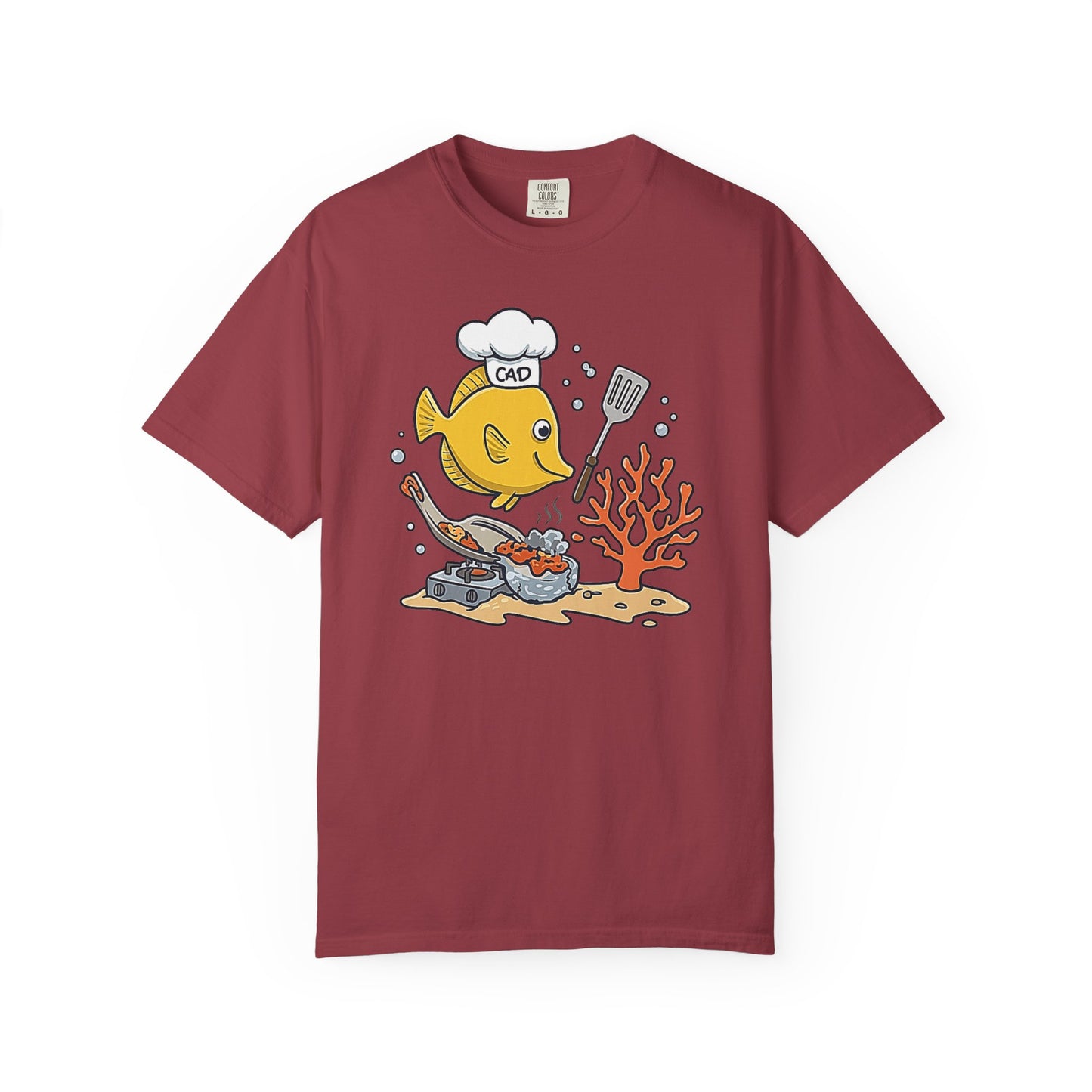 Broke Reefers saltwater aquarium graphic t-shirt featuring a cartoon illustration of a Yellow Tang wearing a chef hat labeled 'CAD' and cooking fish food, maroon crew neck tee