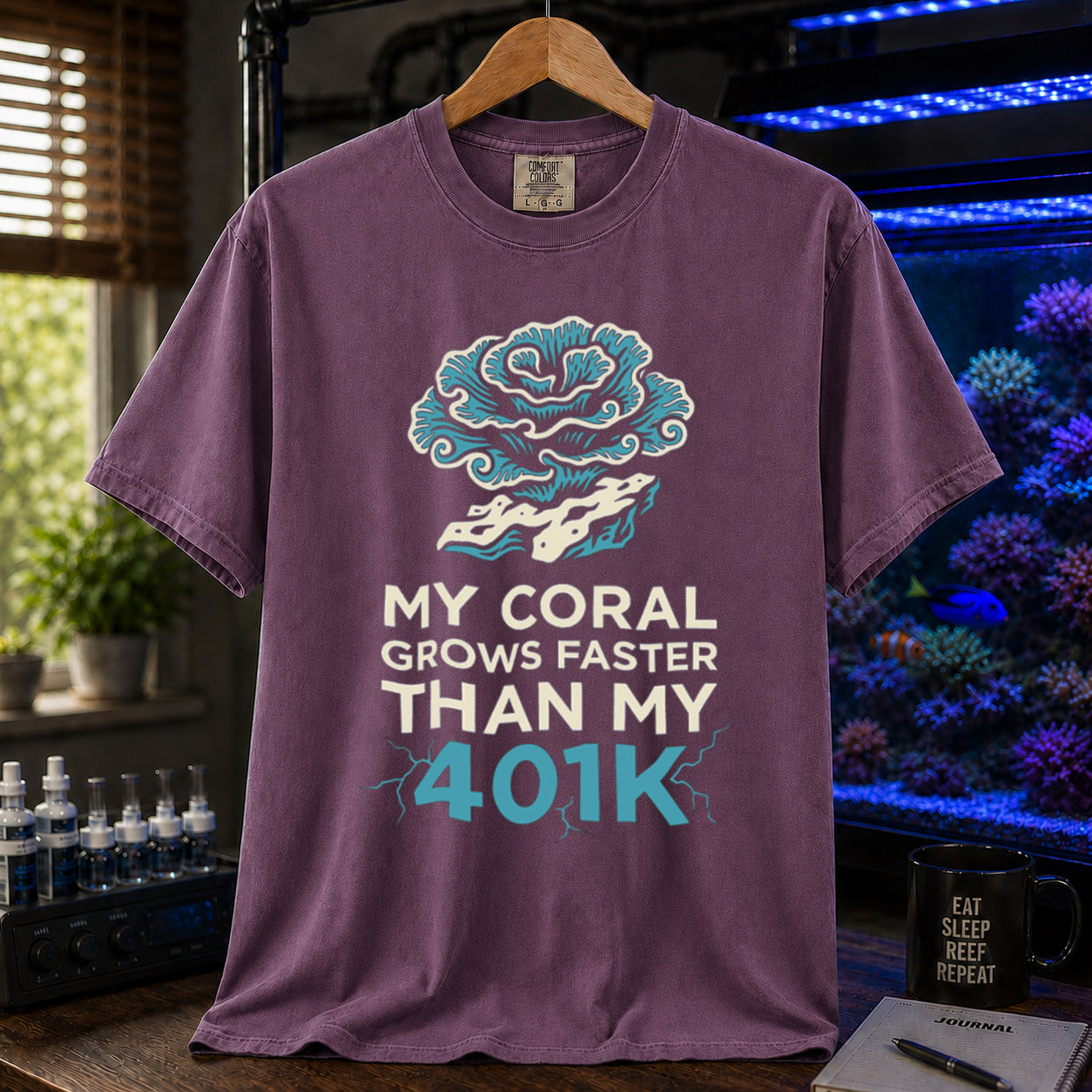 Broke Reefers saltwater aquarium graphic t-shirt featuring an intricate coral illustration and electric blue and white text: MY CORAL GROWS FASTER THAN MY 401K, purple crew neck tee