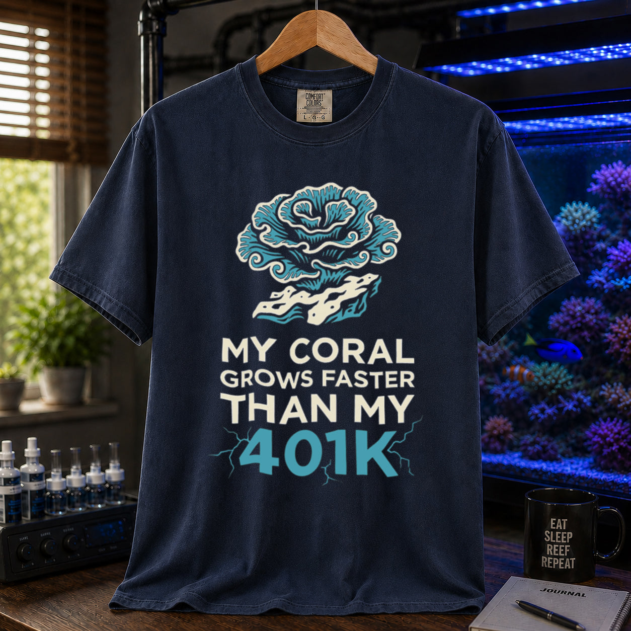 Broke Reefers saltwater aquarium graphic t-shirt featuring an intricate coral illustration and electric blue and white text: MY CORAL GROWS FASTER THAN MY 401K, navy crew neck tee