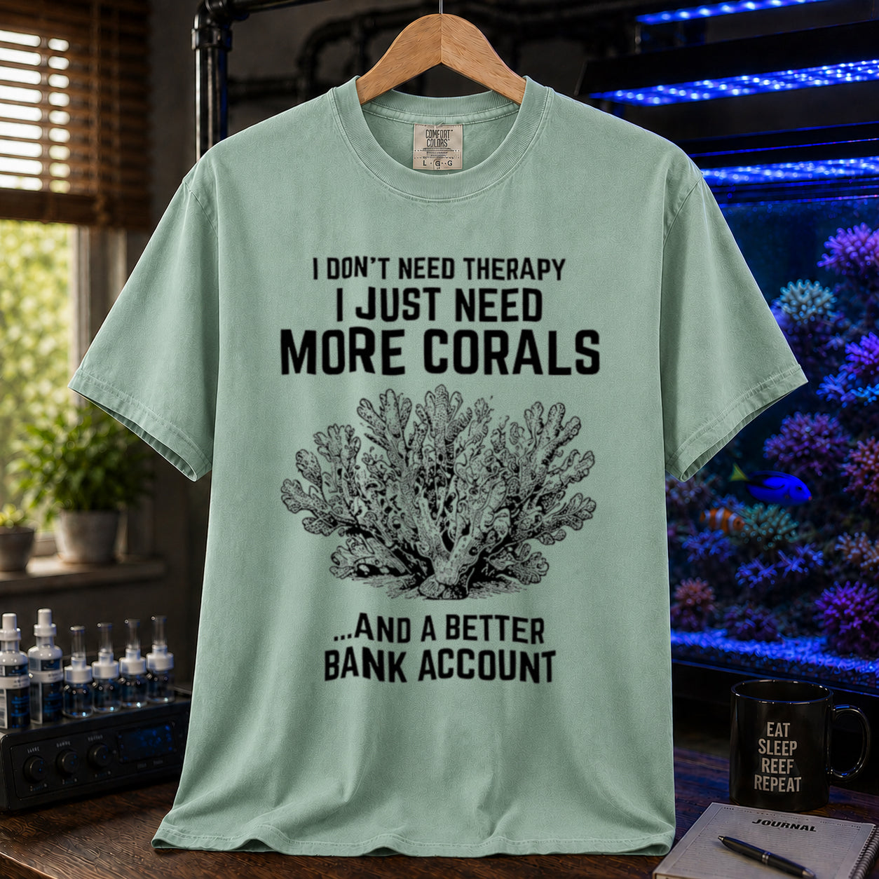 Broke Reefers saltwater aquarium graphic t-shirt featuring an intricate vintage coral illustration and bold text: I DON'T NEED THERAPY I JUST NEED MORE CORALS ...AND A BETTER BANK ACCOUNT, light green crew neck tee