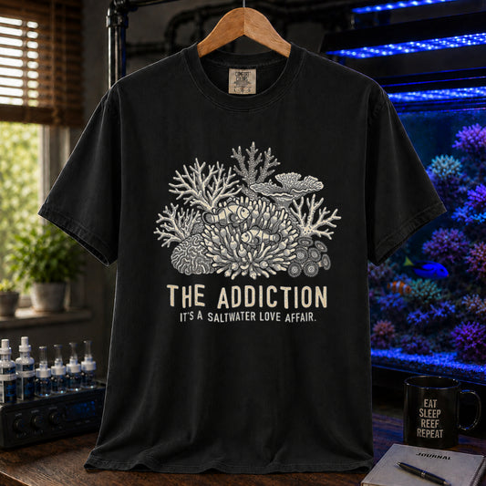 Broke Reefers saltwater aquarium graphic t-shirt featuring an intricate coral and clownfish illustration with the text: THE ADDICTION, IT'S A SALTWATER LOVE AFFAIR, black crew neck tee