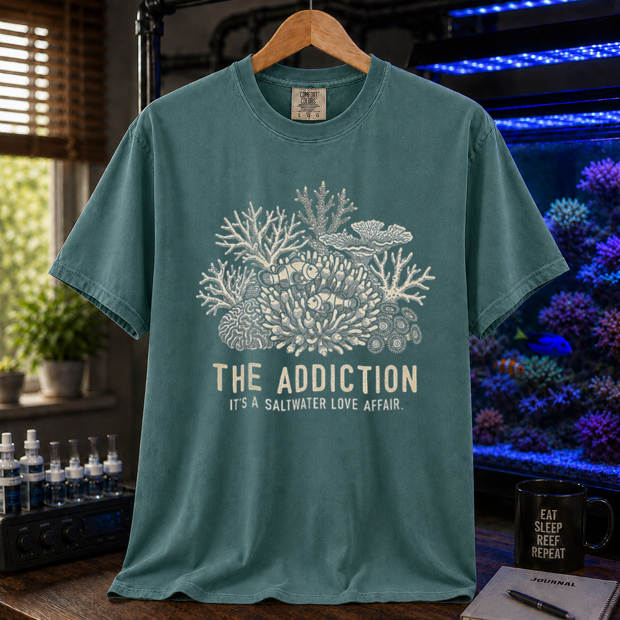 Broke Reefers saltwater aquarium graphic t-shirt featuring an intricate coral and clownfish illustration with the text: THE ADDICTION, IT'S A SALTWATER LOVE AFFAIR, green crew neck tee