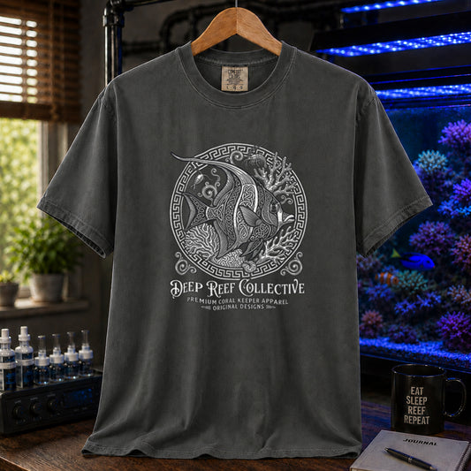 Deep Reef Collective saltwater aquarium graphic t-shirt featuring an ornate circular medallion illustration of a marine fish with the text: DEEP REEF COLLECTIVE, PREMIUM CORAL KEEPER APPAREL, ORIGINAL DESIGNS, khaki crew neck tee