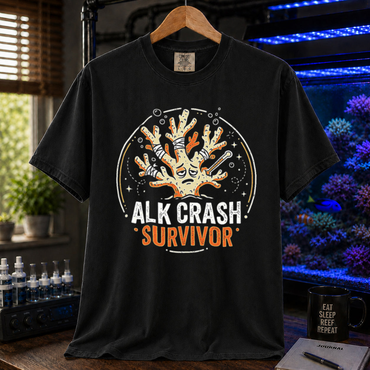 Saltwater aquarium graphic t-shirt featuring a cartoon illustration of a bandaged coral and text: ALK CRASH SURVIVOR, black crew neck tee