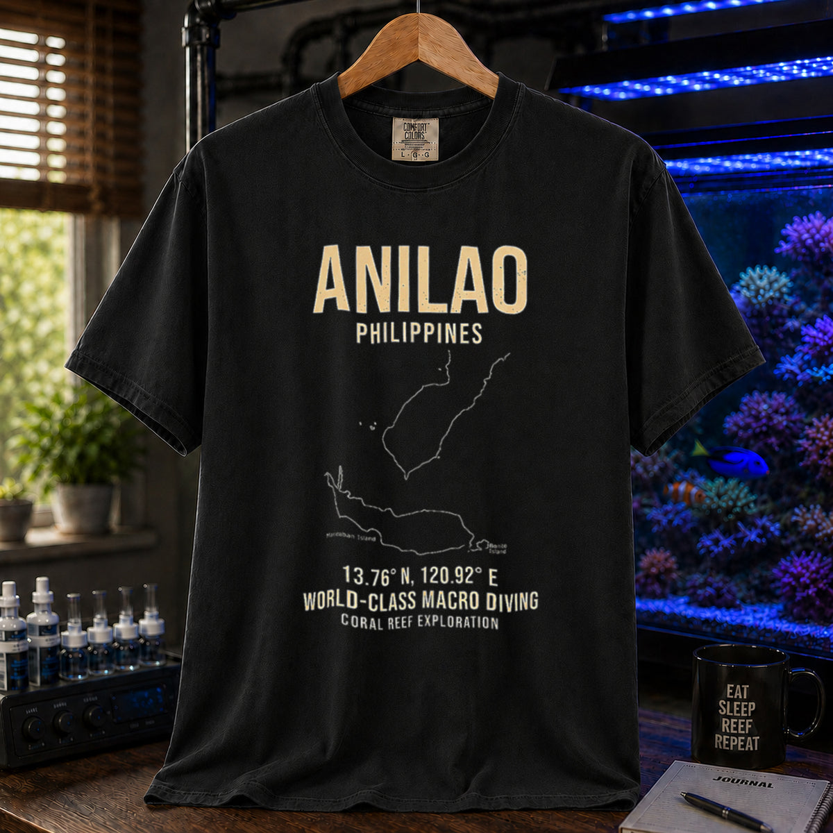 Saltwater aquarium graphic t-shirt featuring a map outline of Anilao, Philippines, coordinates, and the text: ANILAO PHILIPPINES, 13.76 N, 120.92 E, WORLD-CLASS MACRO DIVING, CORAL REEF EXPLORATION, black crew neck tee