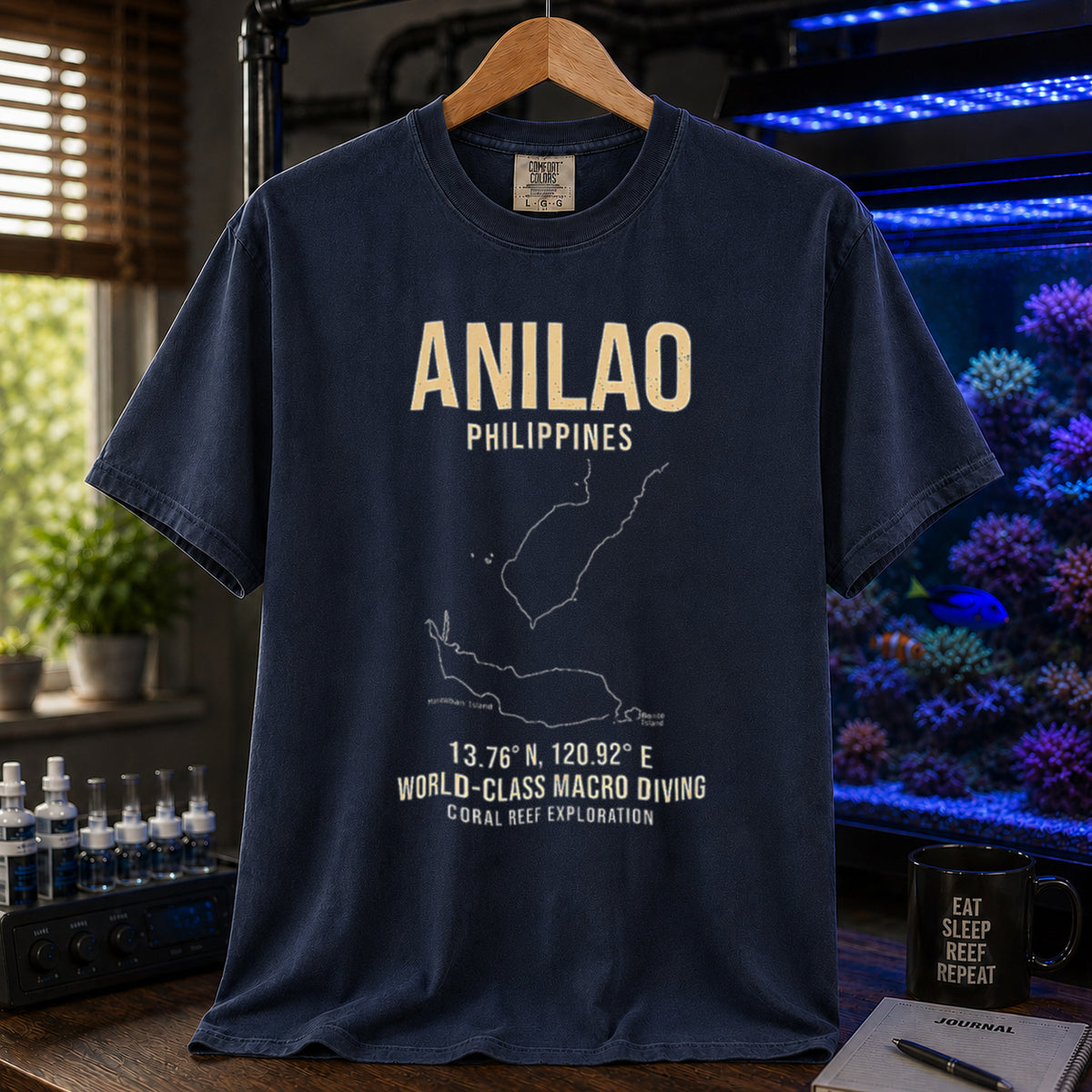 Saltwater aquarium graphic t-shirt featuring a map outline of Anilao, Philippines, coordinates, and the text: ANILAO PHILIPPINES, 13.76 N, 120.92 E, WORLD-CLASS MACRO DIVING, CORAL REEF EXPLORATION, navy crew neck tee