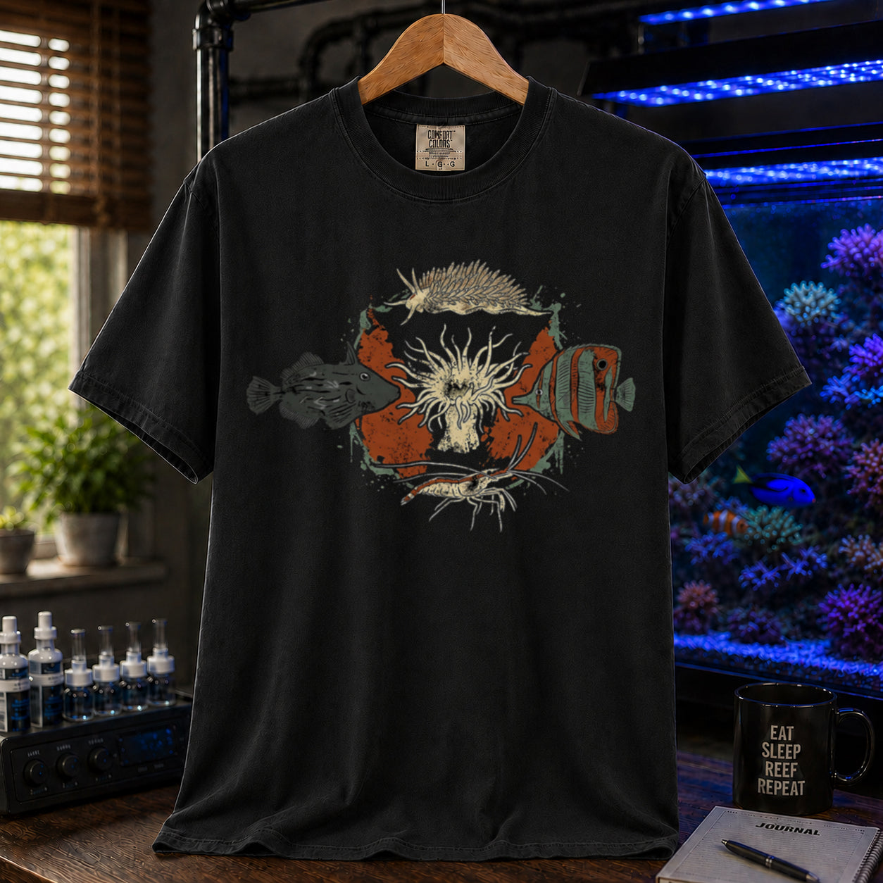 Saltwater aquarium graphic t-shirt featuring an illustration of biological Aiptasia predators surrounding an anemone and text: AIPTASIA CONTROL, black crew neck tee
