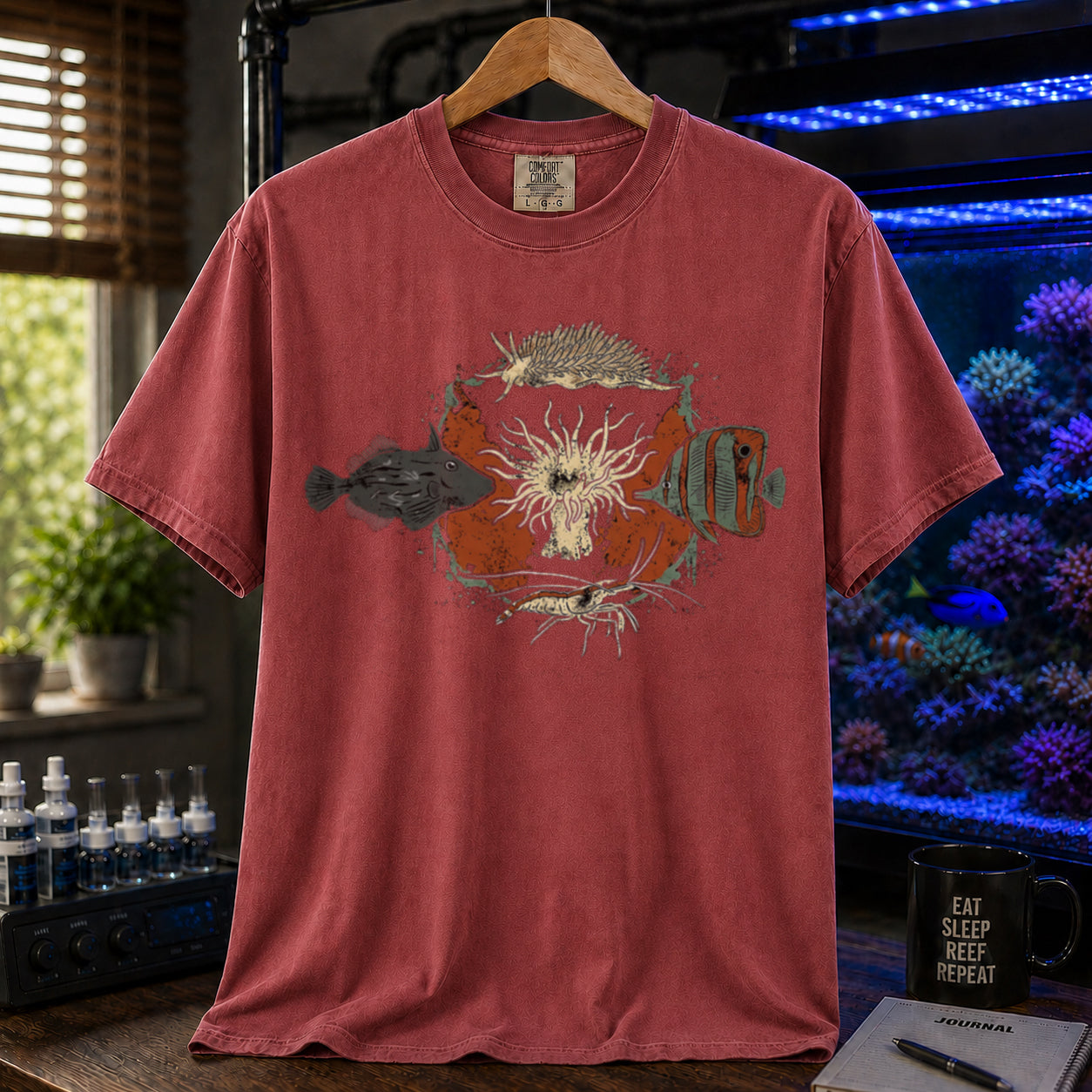 Saltwater aquarium graphic t-shirt featuring an illustration of biological Aiptasia predators surrounding an anemone and text: AIPTASIA CONTROL, maroon crew neck tee
