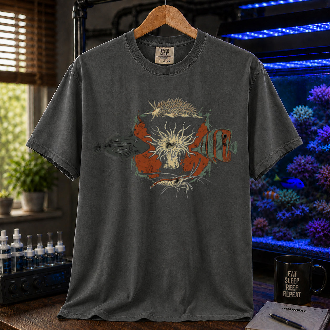 Saltwater aquarium graphic t-shirt featuring an illustration of biological Aiptasia predators surrounding an anemone and text: AIPTASIA CONTROL, khaki crew neck tee