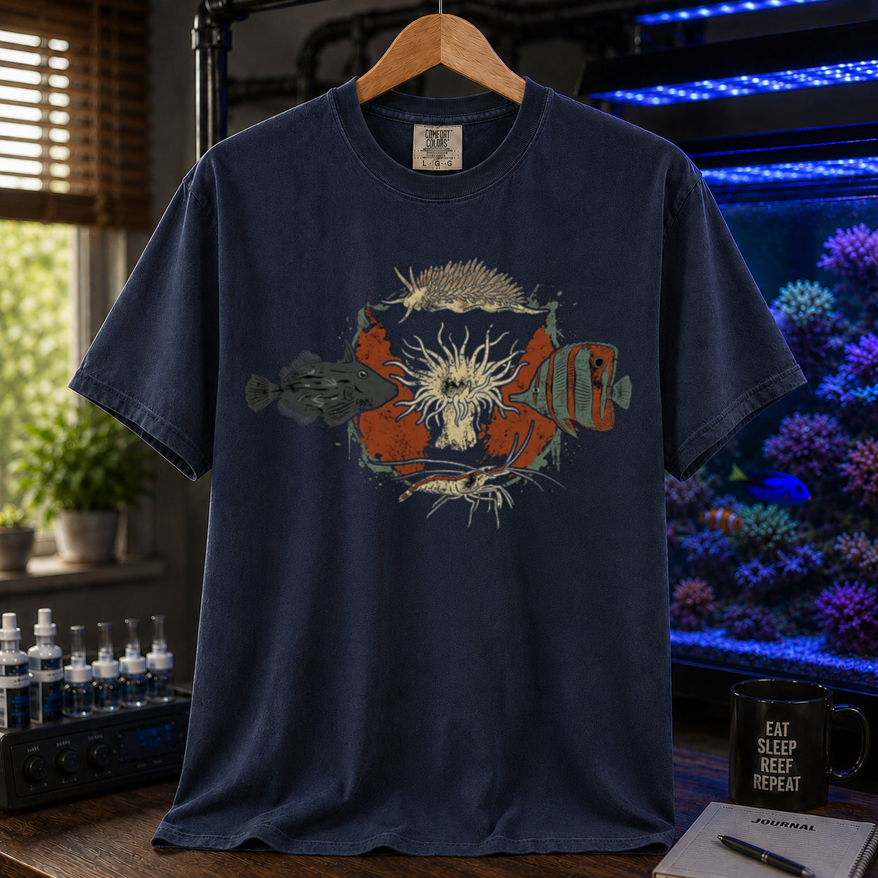 Saltwater aquarium graphic t-shirt featuring an illustration of biological Aiptasia predators surrounding an anemone and text: AIPTASIA CONTROL, navy crew neck tee