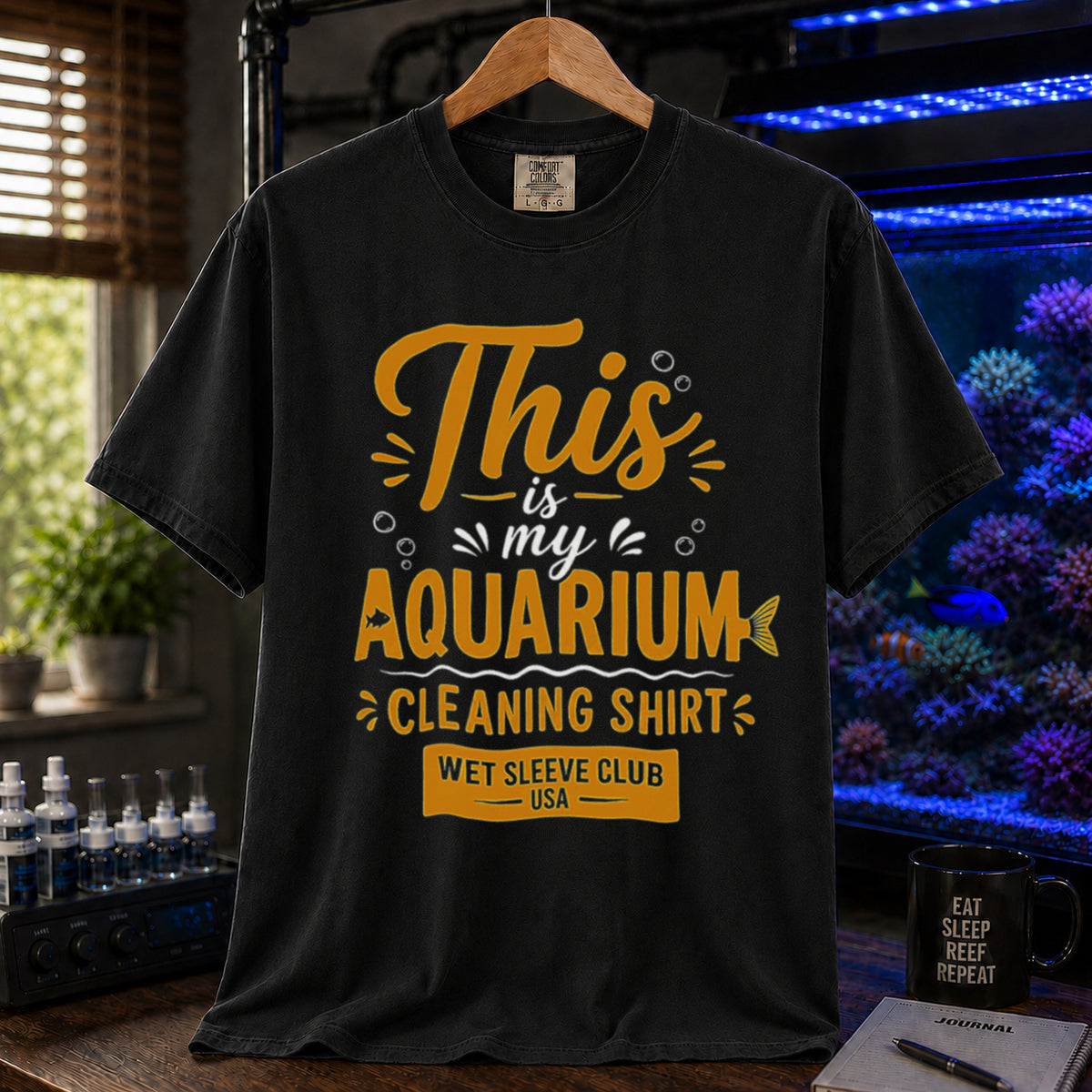 Saltwater aquarium graphic t-shirt featuring bold gold and white text: THIS IS MY AQUARIUM CLEANING SHIRT, WET SLEEVE CLUB USA, black crew neck tee