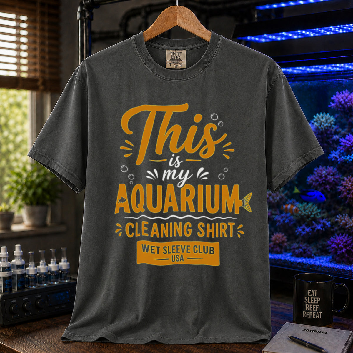 Saltwater aquarium graphic t-shirt featuring bold gold and white text: THIS IS MY AQUARIUM CLEANING SHIRT, WET SLEEVE CLUB USA, khaki crew neck tee