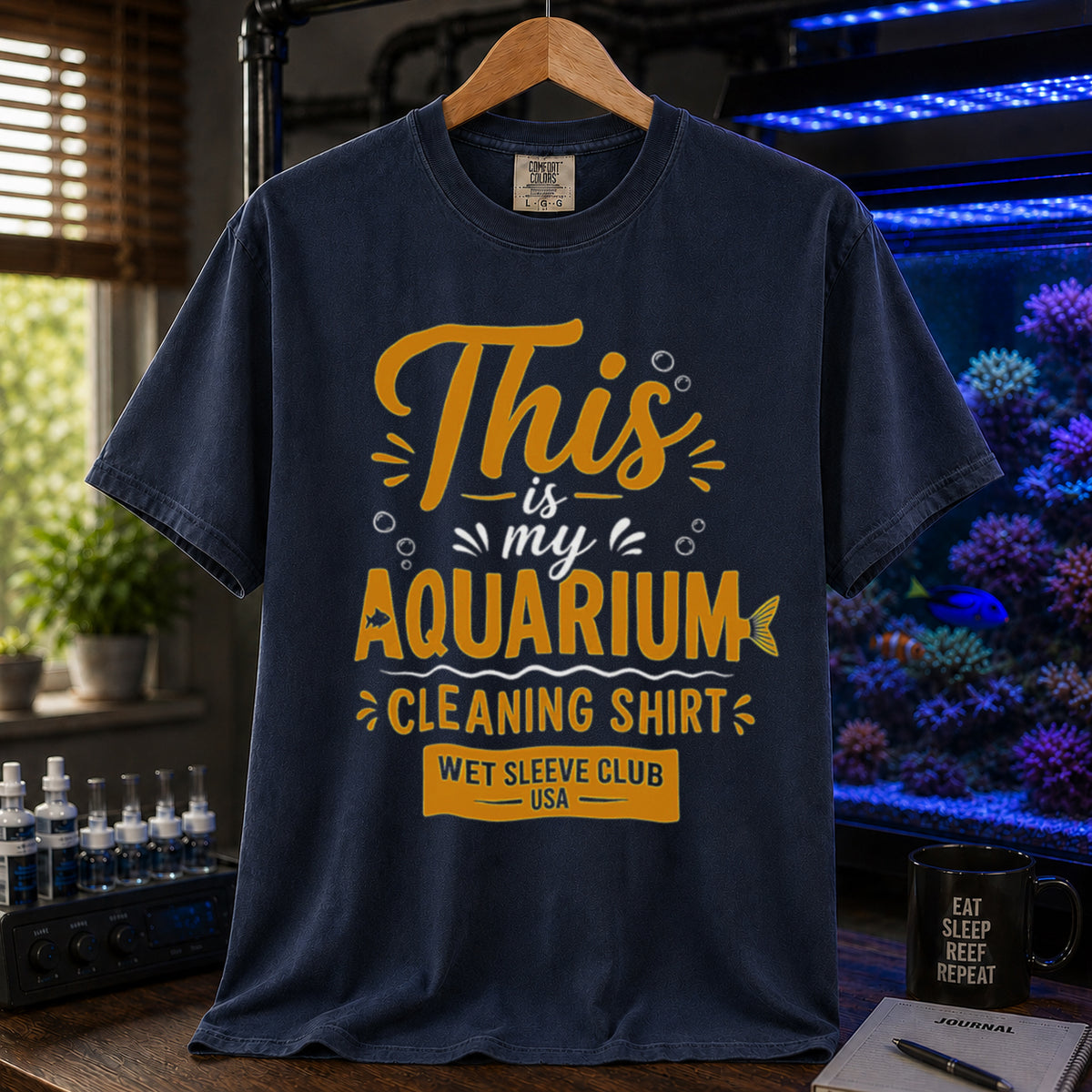 Saltwater aquarium graphic t-shirt featuring bold gold and white text: THIS IS MY AQUARIUM CLEANING SHIRT, WET SLEEVE CLUB USA, navy crew neck tee