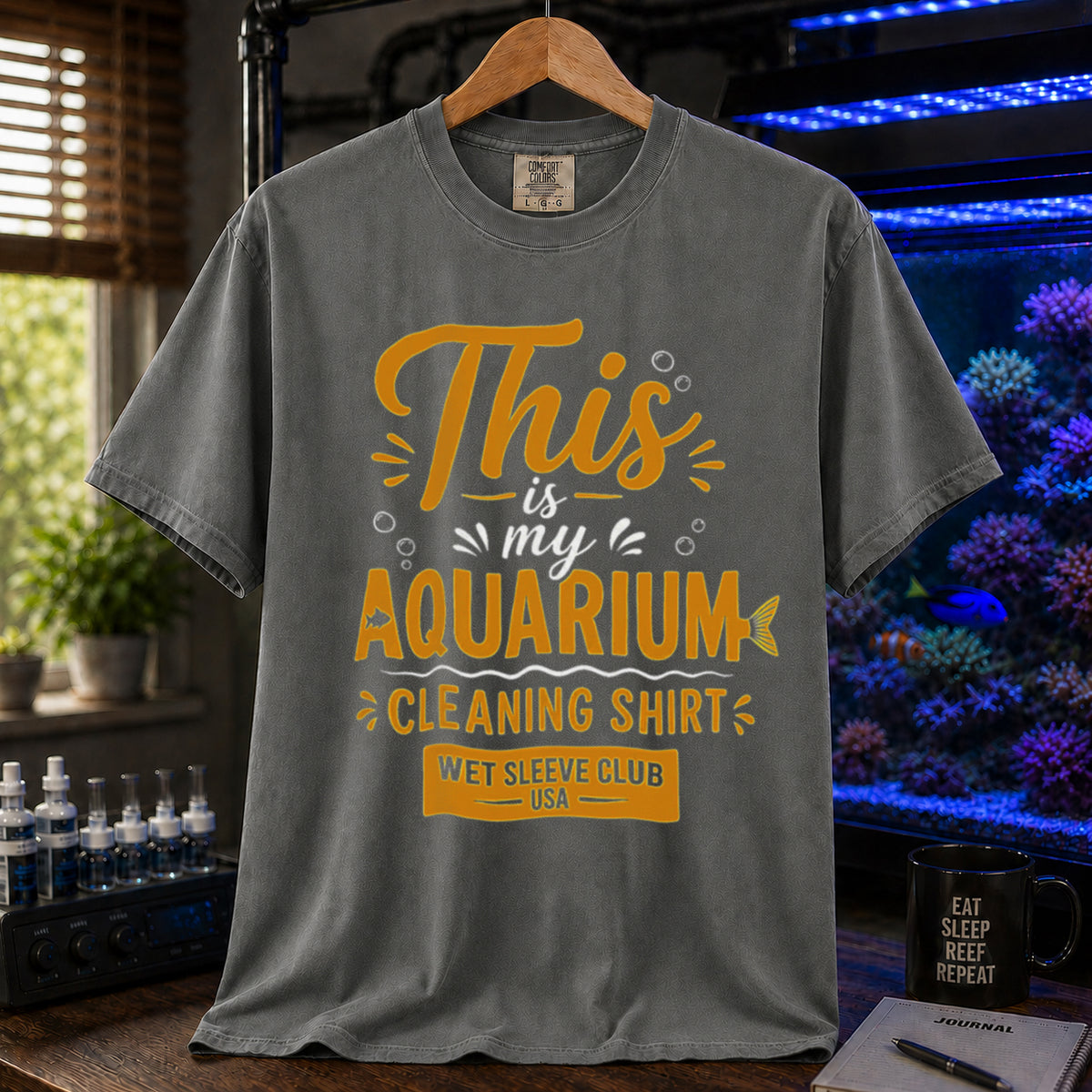 Saltwater aquarium graphic t-shirt featuring bold gold and white text: THIS IS MY AQUARIUM CLEANING SHIRT, WET SLEEVE CLUB USA, khaki crew neck tee