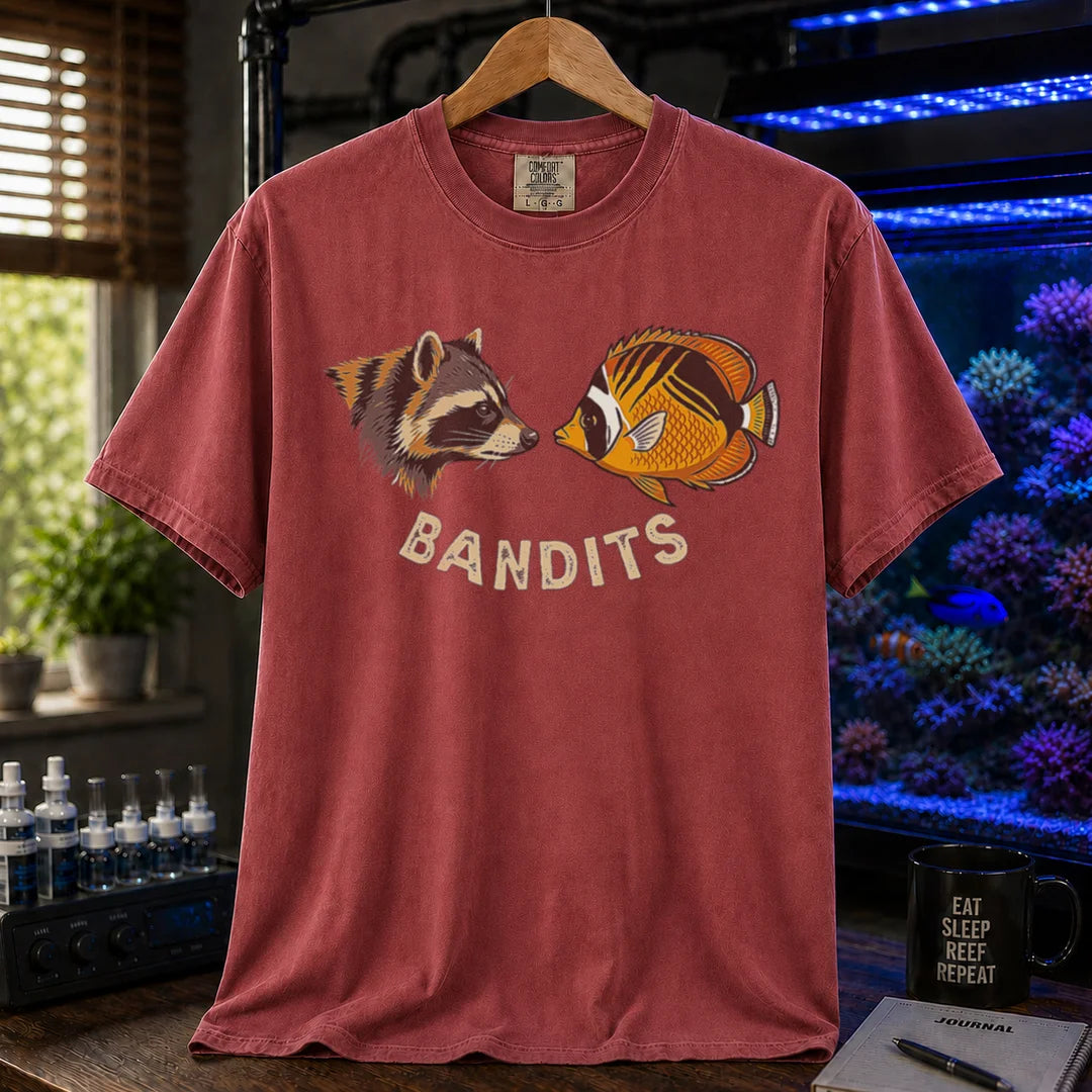 Saltwater aquarium graphic t-shirt featuring a vintage illustration of a raccoon and a Bandit Angelfish face-to-face with the text: BANDITS, maroon crew neck tee