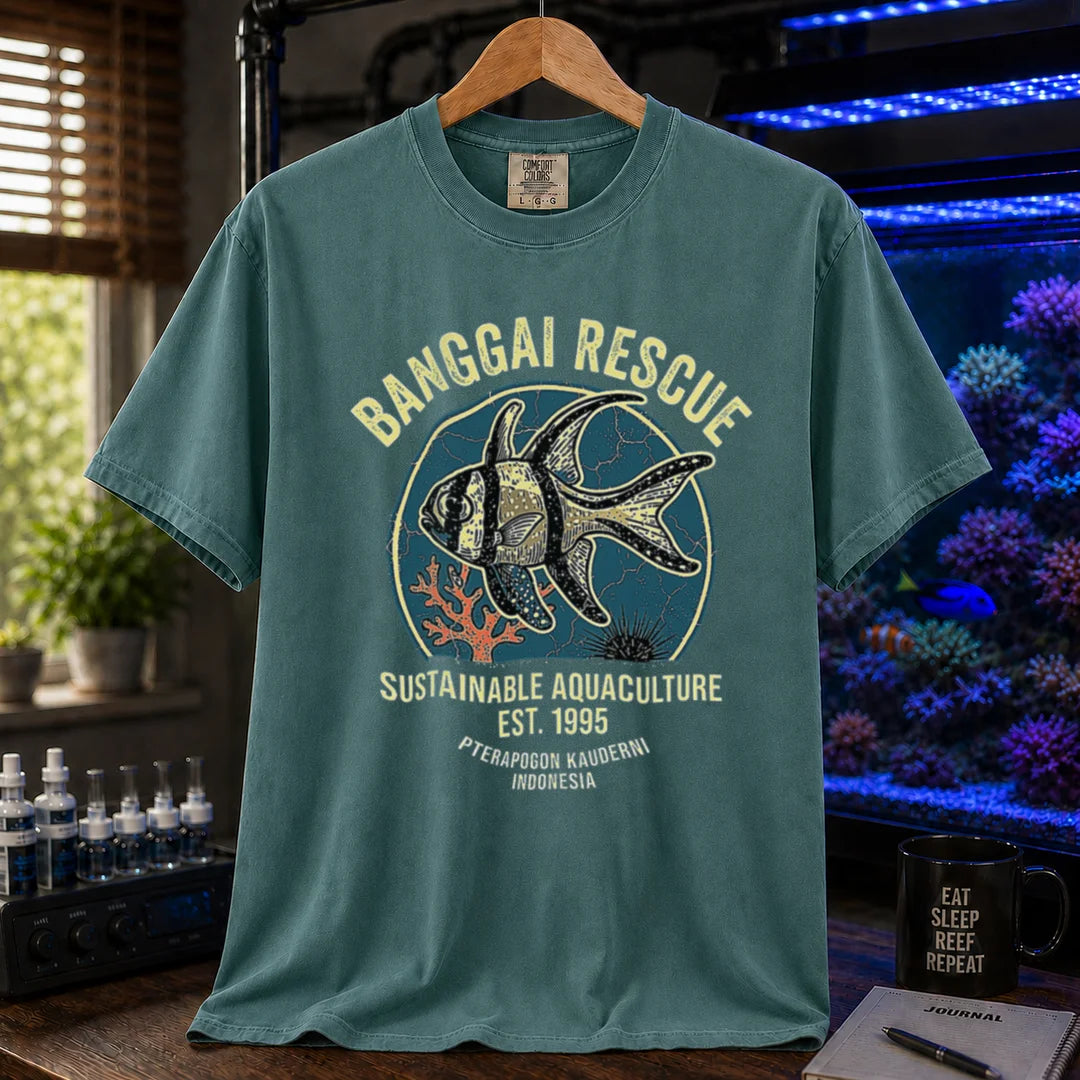 Saltwater aquarium graphic t-shirt featuring a retro emblem of a Banggai Cardinalfish and text: BANGGAI RESCUE, SUSTAINABLE REEFKEEPING, EST. 1995, PTERAPOGON KAUDERNI, INDONESIA, green crew neck tee