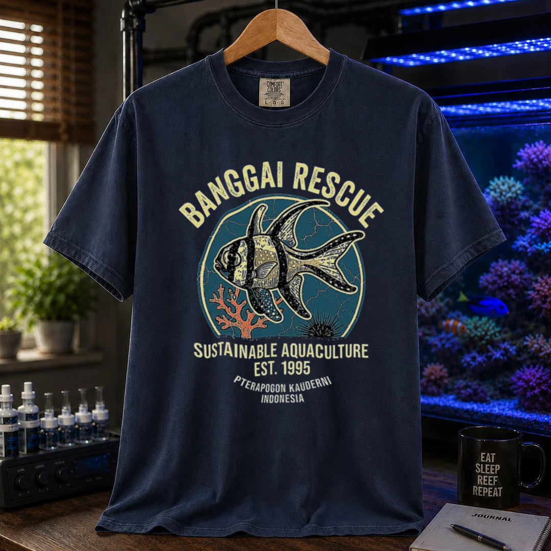 Saltwater aquarium graphic t-shirt featuring a retro emblem of a Banggai Cardinalfish and text: BANGGAI RESCUE, SUSTAINABLE REEFKEEPING, EST. 1995, PTERAPOGON KAUDERNI, INDONESIA, navy crew neck tee