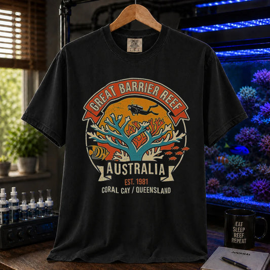 Saltwater aquarium graphic t-shirt featuring a retro colorful emblem of a scuba diver over a coral reef and text: GREAT BARRIER REEF, AUSTRALIA, EST. 1981, CORAL CAY / QUEENSLAND, black crew neck tee