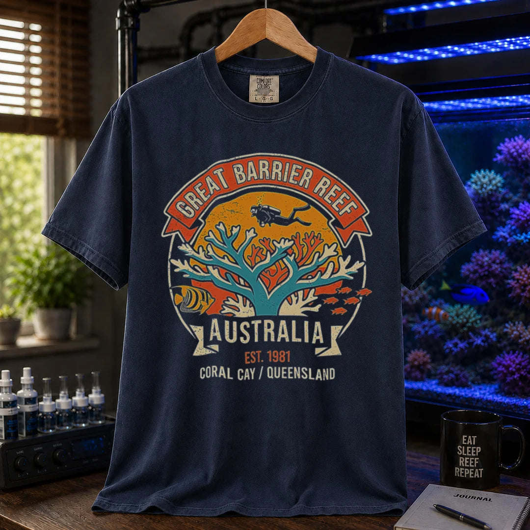 Saltwater aquarium graphic t-shirt featuring a retro colorful emblem of a scuba diver over a coral reef and text: GREAT BARRIER REEF, AUSTRALIA, EST. 1981, CORAL CAY / QUEENSLAND, navy crew neck tee
