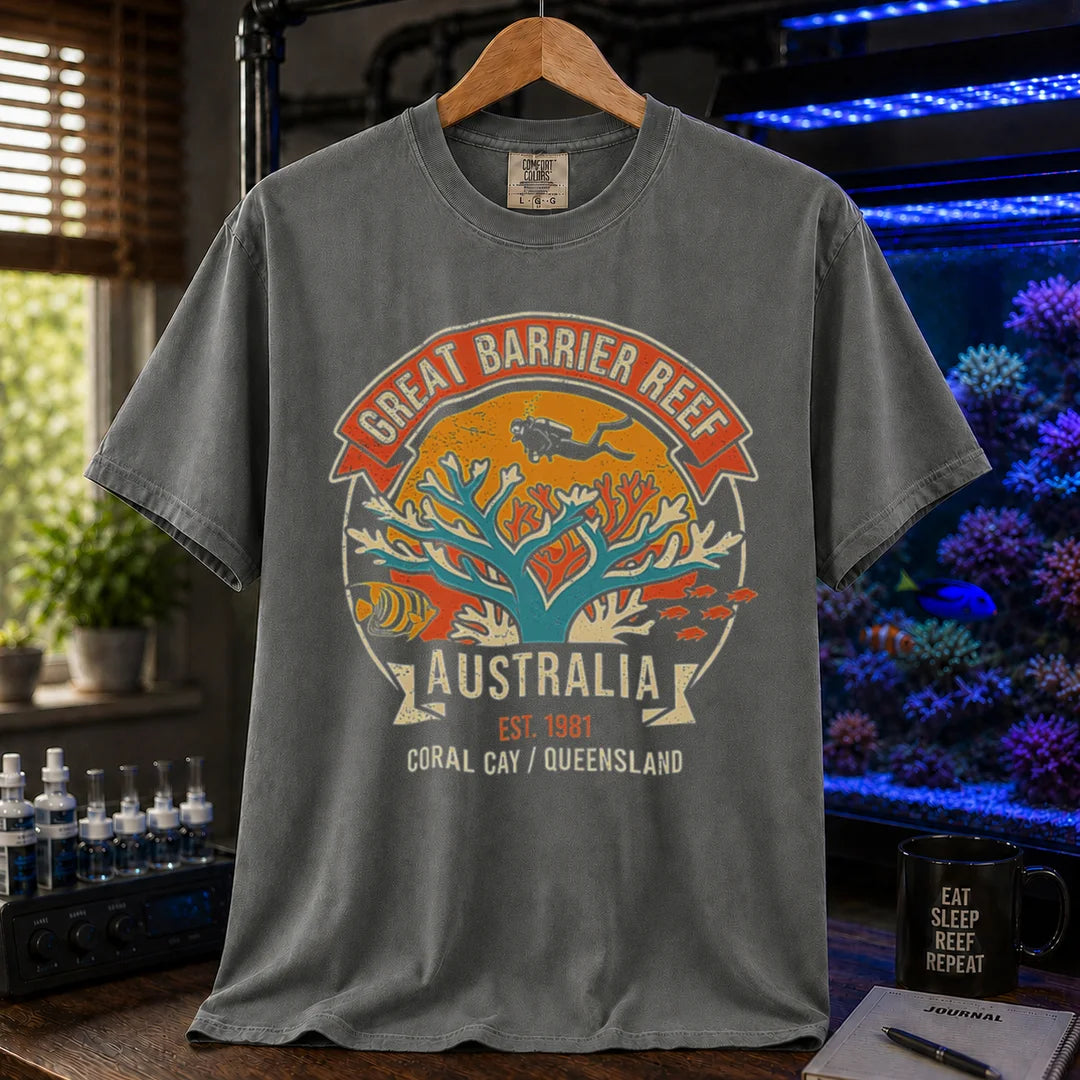 Saltwater aquarium graphic t-shirt featuring a retro colorful emblem of a scuba diver over a coral reef and text: GREAT BARRIER REEF, AUSTRALIA, EST. 1981, CORAL CAY / QUEENSLAND, khaki crew neck tee