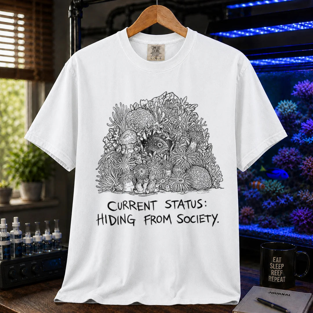Saltwater aquarium graphic t-shirt on a pure solid white fabric background featuring an ink illustration of a fish hiding in coral and text: CURRENT STATUS: HIDING FROM SOCIETY,  white crew neck tee