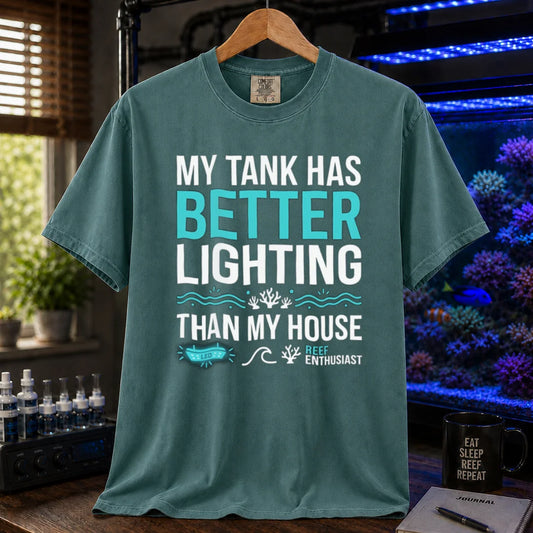 Saltwater aquarium graphic t-shirt featuring bold typography and reef icons with the text: MY TANK HAS BETTER LIGHTING THAN MY HOUSE,  green crew neck tee