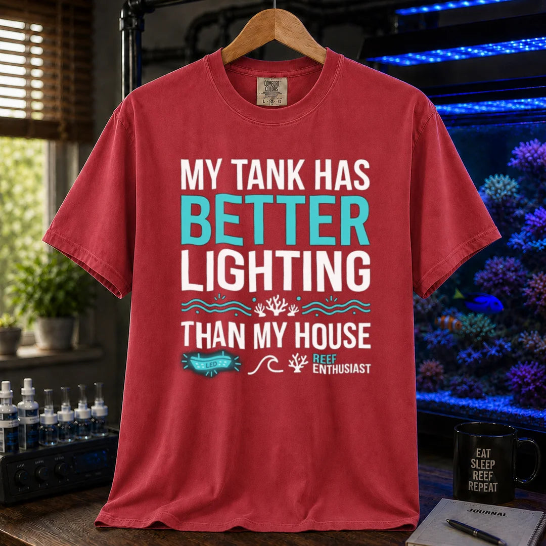 Saltwater aquarium graphic t-shirt featuring bold typography and reef icons with the text: MY TANK HAS BETTER LIGHTING THAN MY HOUSE,  maroon crew neck tee