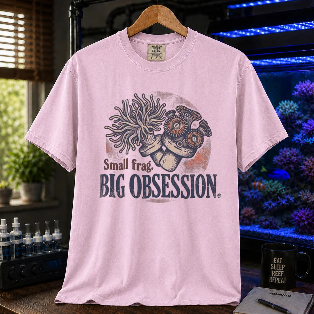 Saltwater aquarium graphic t-shirt on a pure solid white fabric background featuring an illustration of coral frags and text: Small frag. BIG OBSESSION., pink crew neck tee