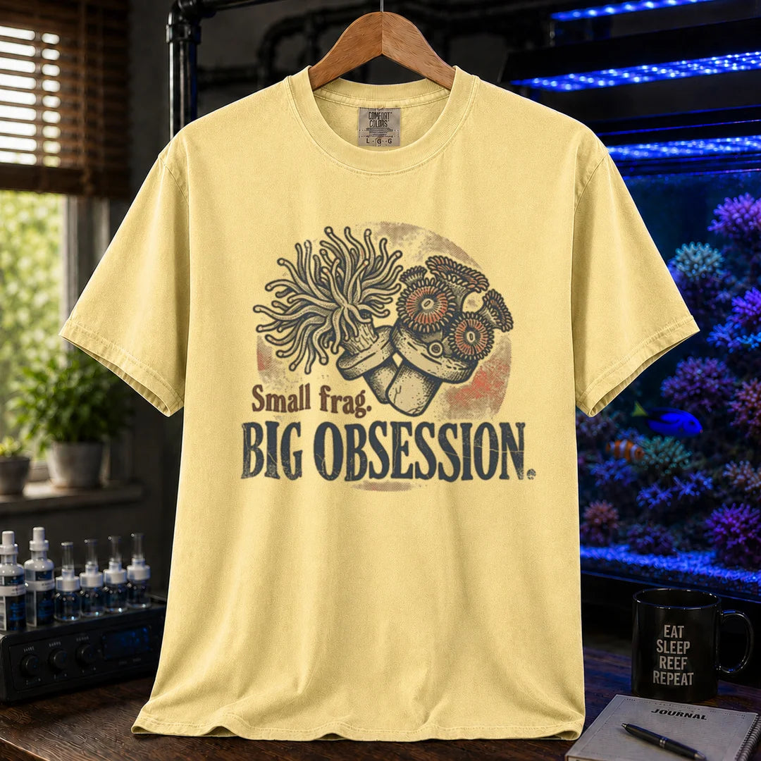 Saltwater aquarium graphic t-shirt on a pure solid white fabric background featuring an illustration of coral frags and text: Small frag. BIG OBSESSION., yellow crew neck tee