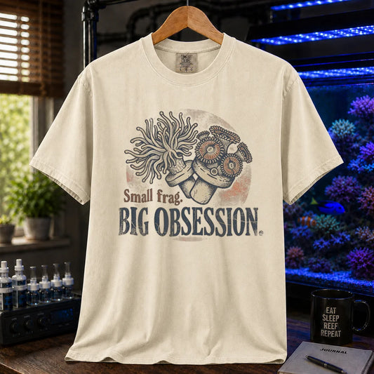 Saltwater aquarium graphic t-shirt on a pure solid white fabric background featuring an illustration of coral frags and text: Small frag. BIG OBSESSION., cream, beige, ivory crew neck tee